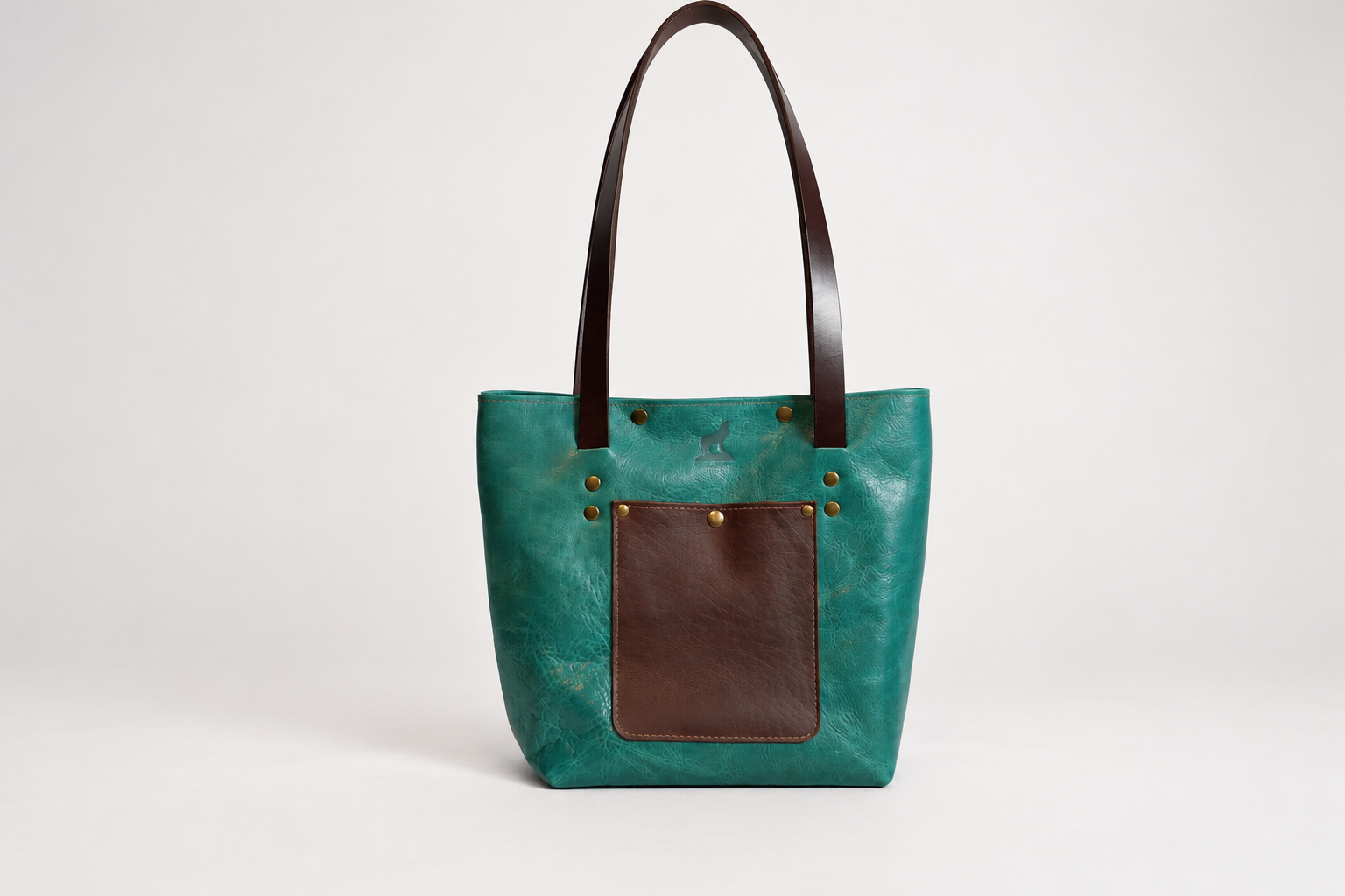 Teal leather bag on clean studio backdrop-2.png