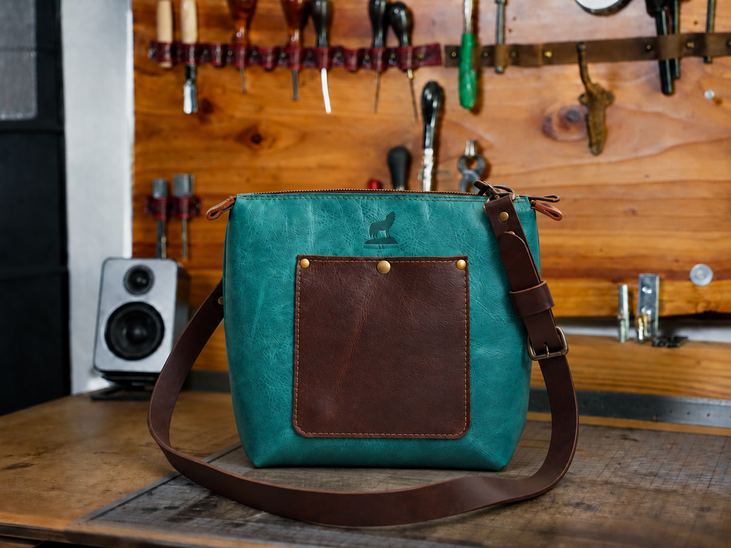 Teal Pinnacle Crossbody on a Workshop Bench.png