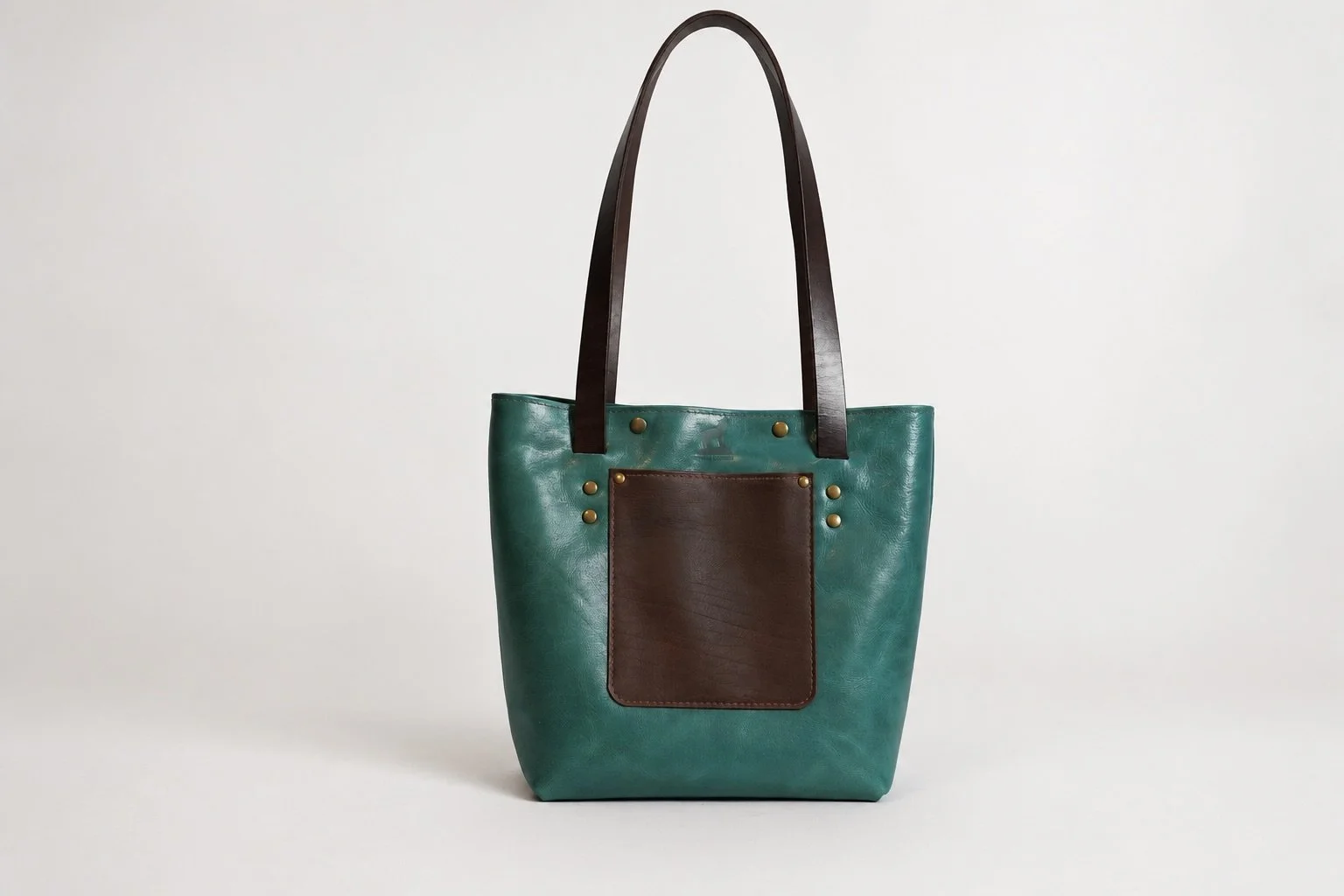 Teal leather bag on clean backdrop-1.jpeg