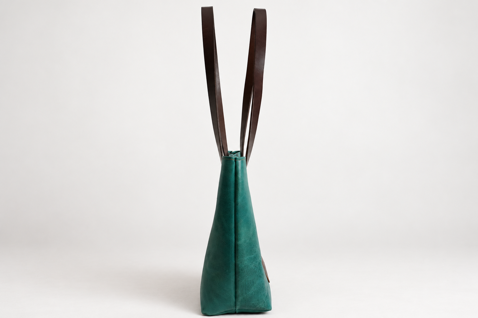 Teal leather bag on a clean backdrop-3.png