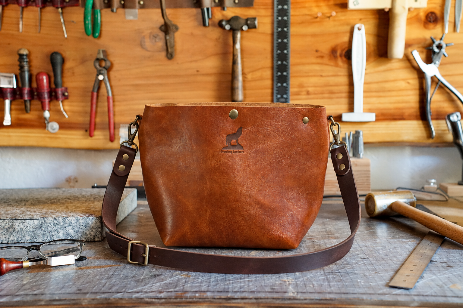 Handcrafted Cognac Satchel on Workshop Bench.png