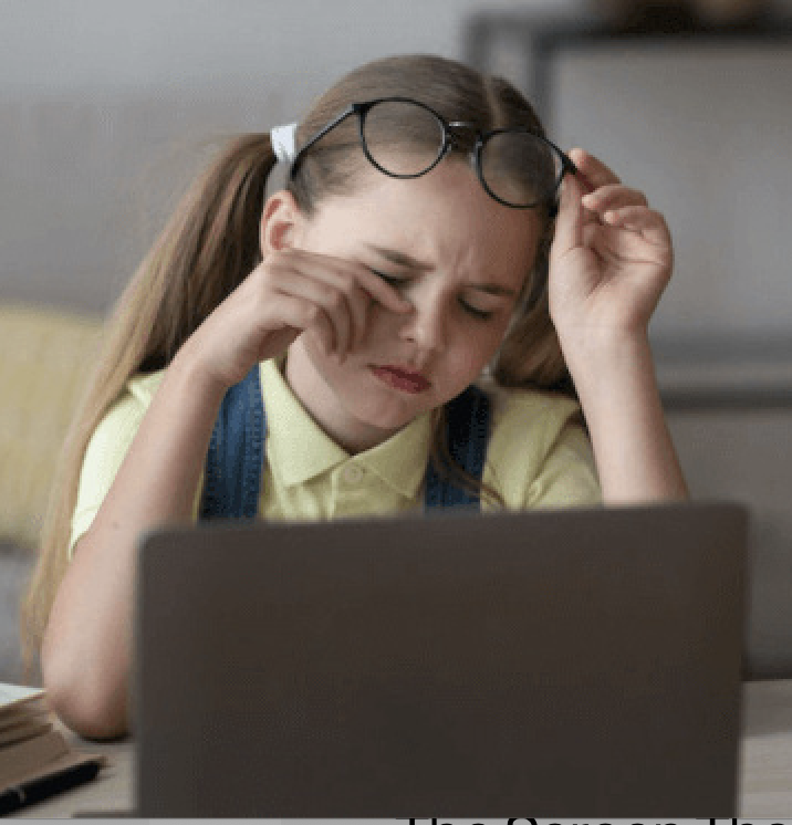 Girl rubbing eyes on laptop