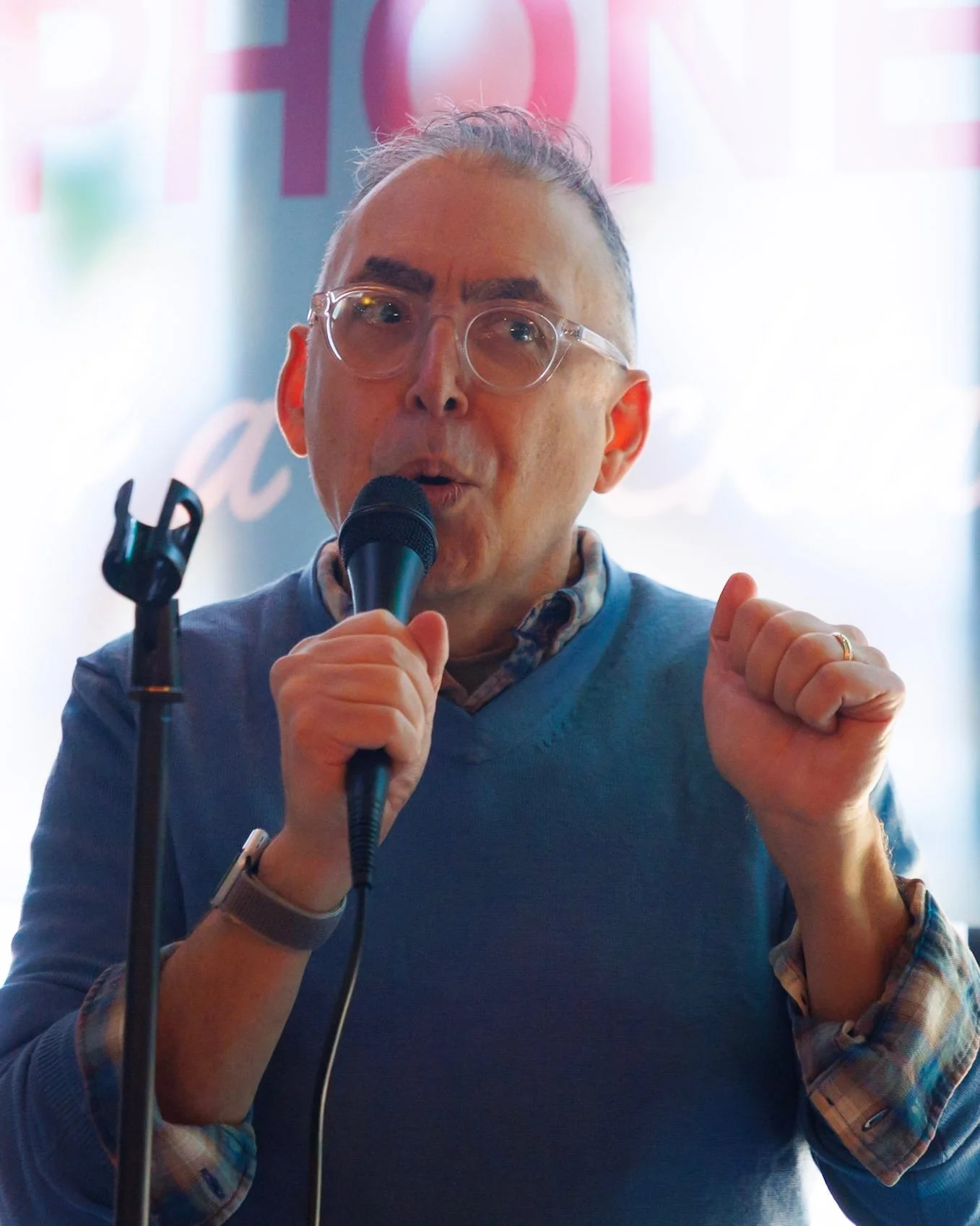 A man with a microphone addresses the crowd