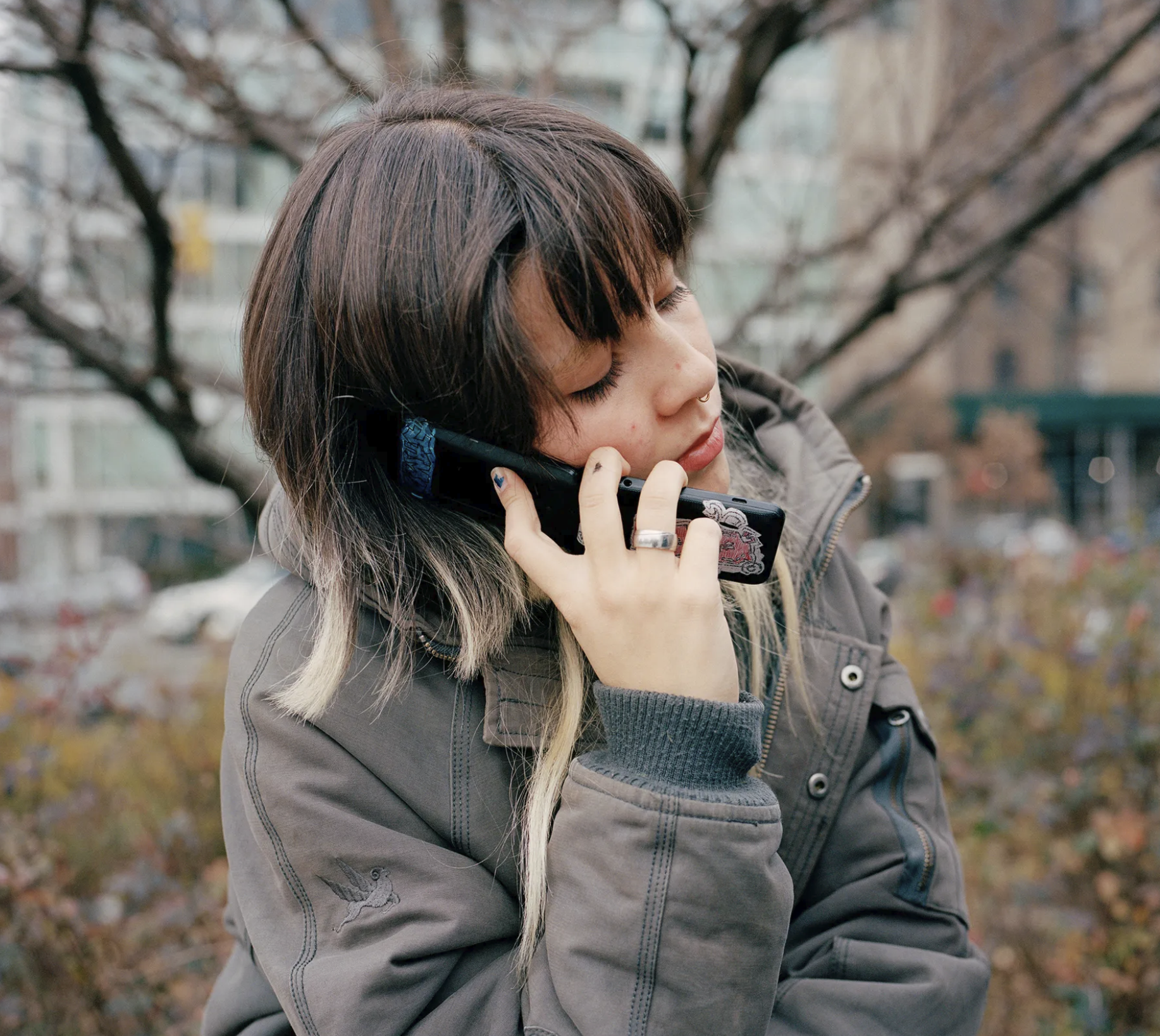 Young woman on a flip phone