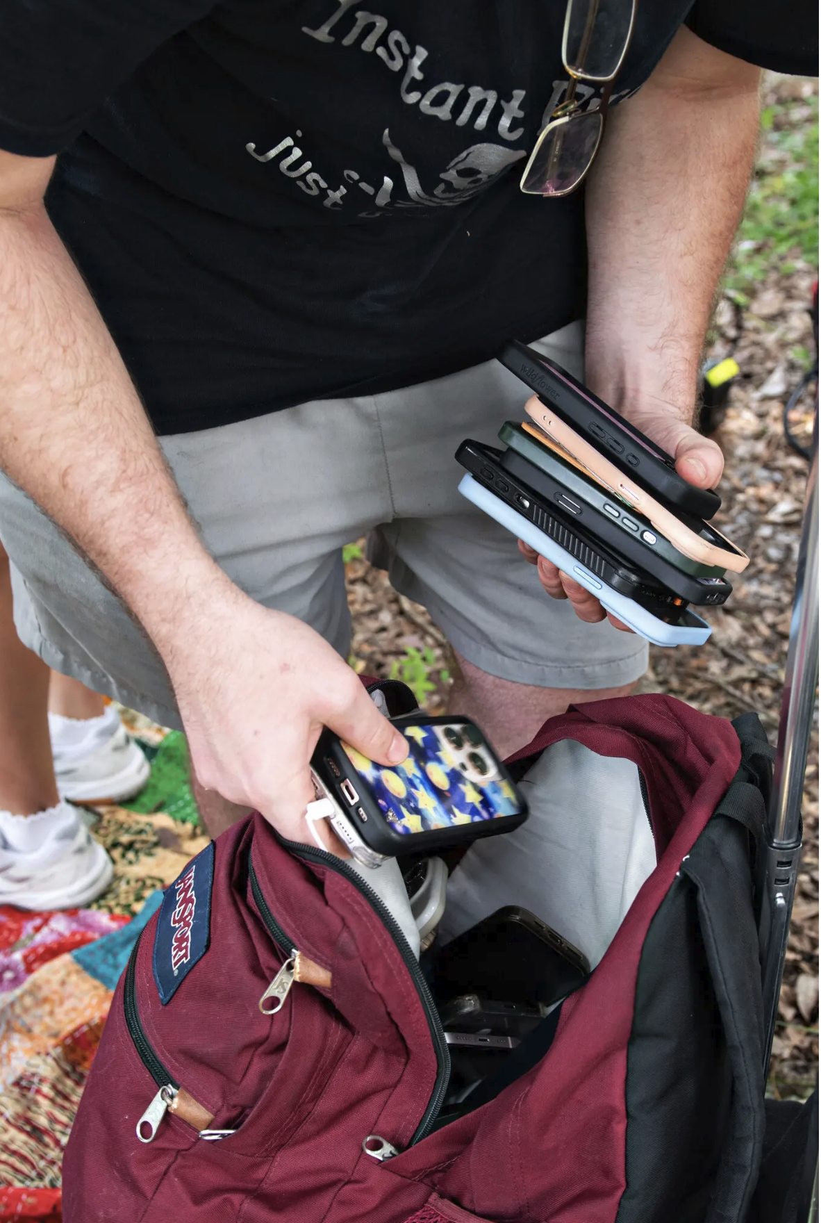 Student stores smartphones in a backpack
