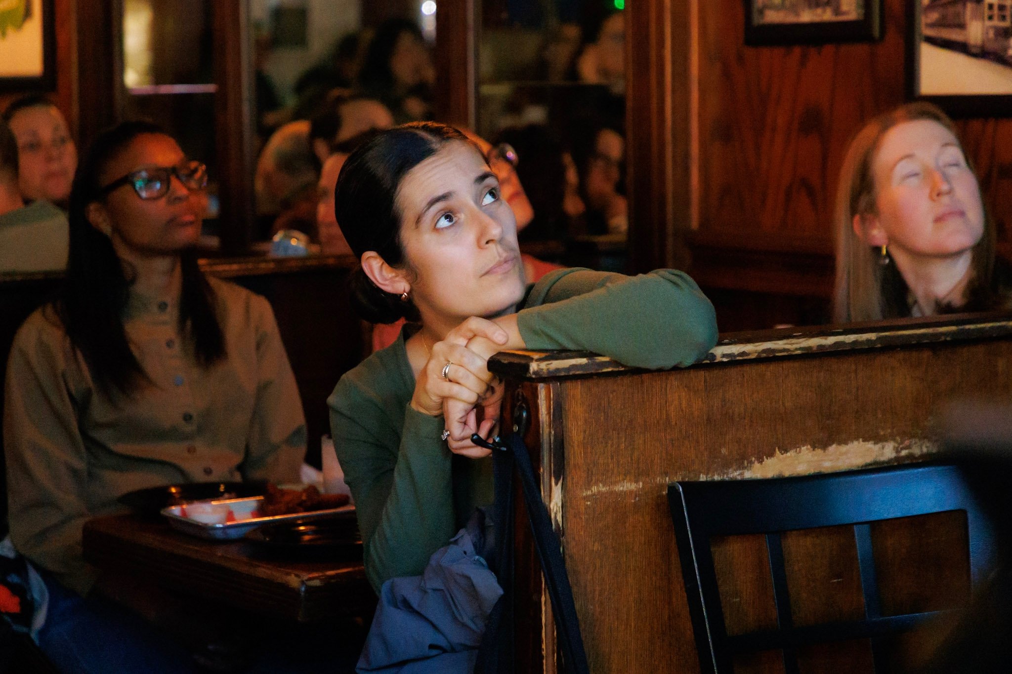 woman listening to presentation in a restaurant's seat