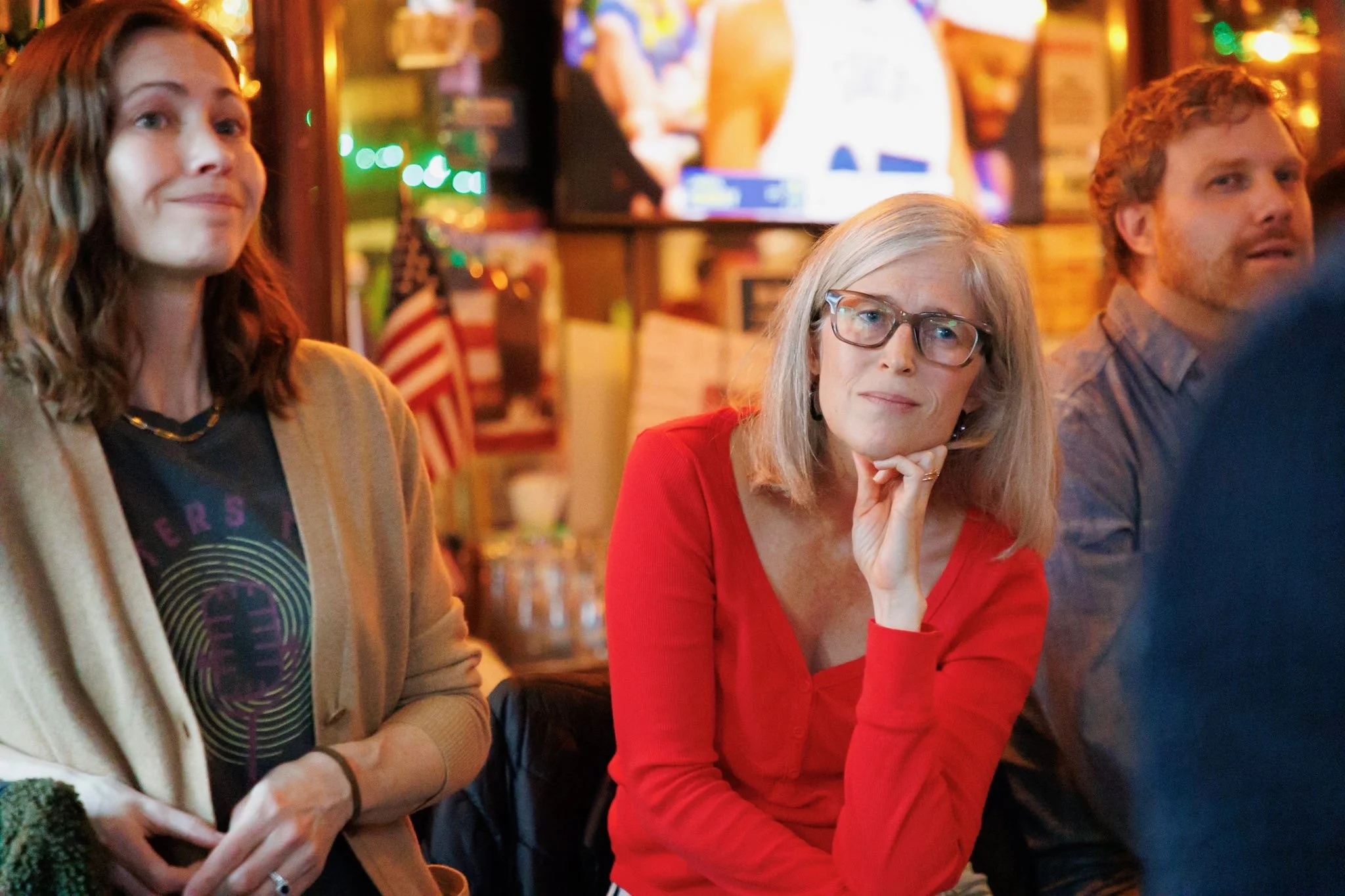 A woman in red listens to the presentation