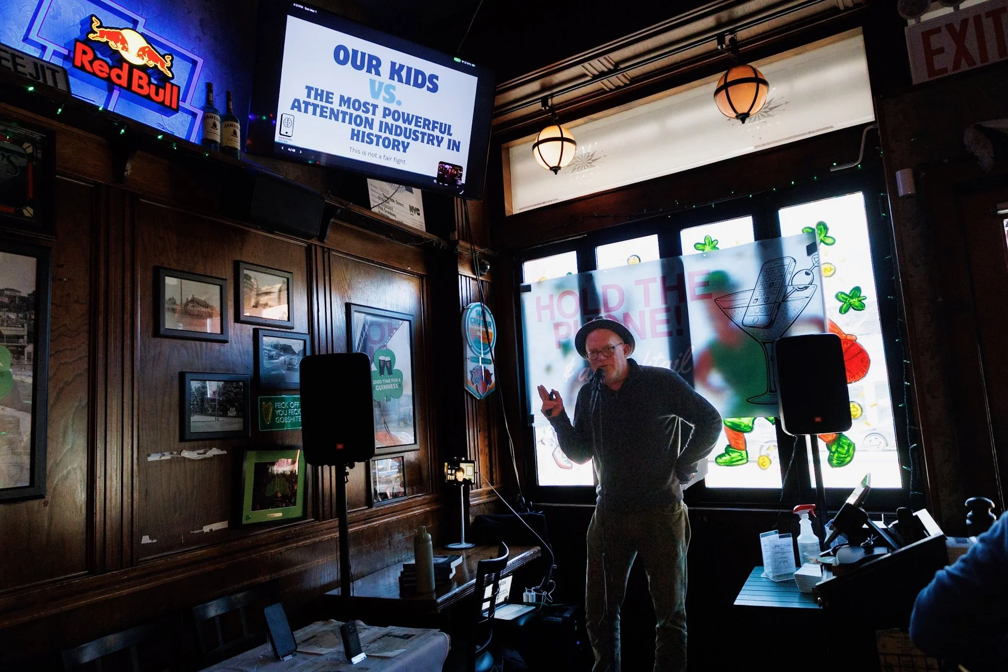 A man in a hat addresses the crowd