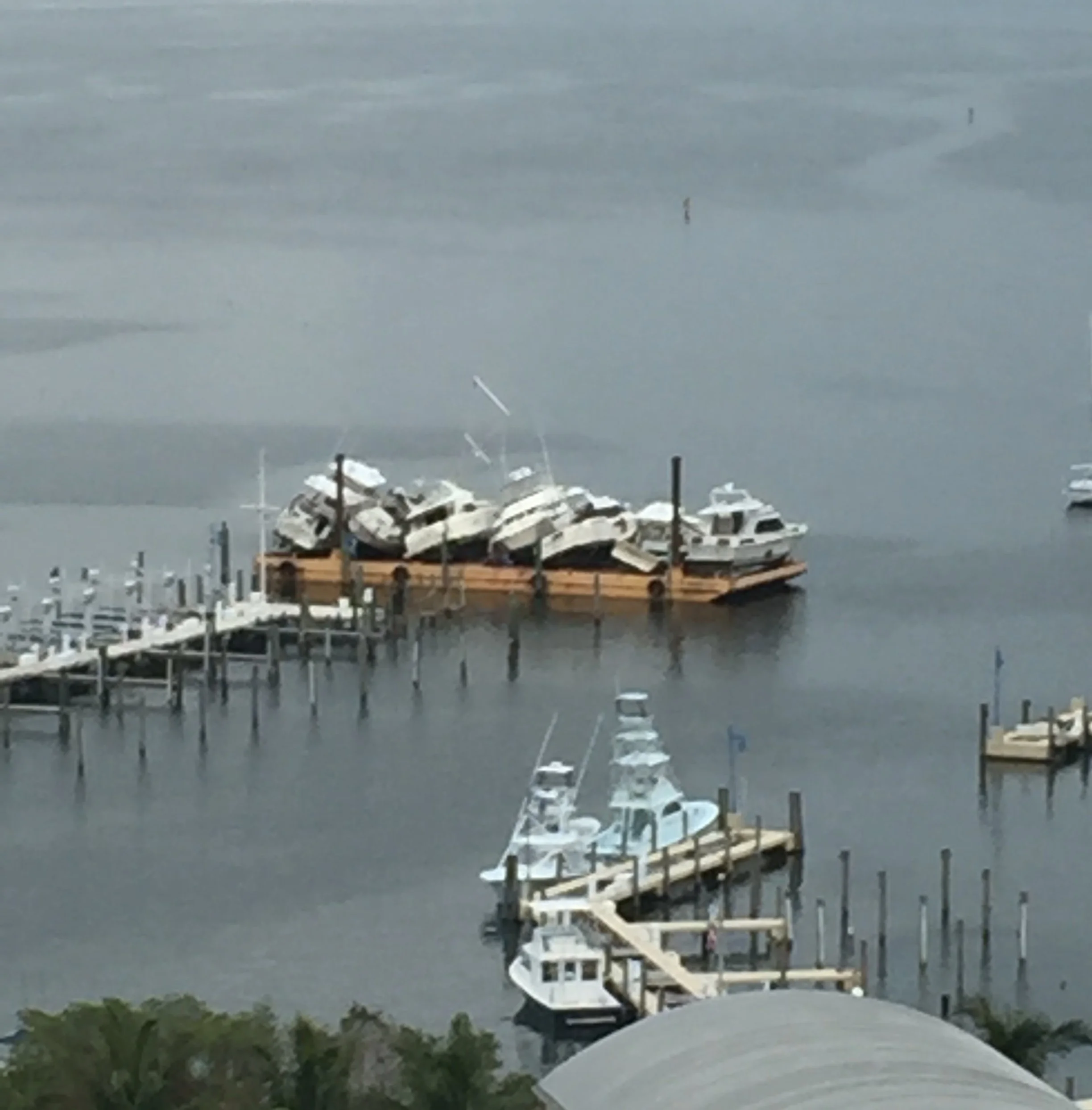Damaged boats on barge after 2017 hurricane, Coconut Grove