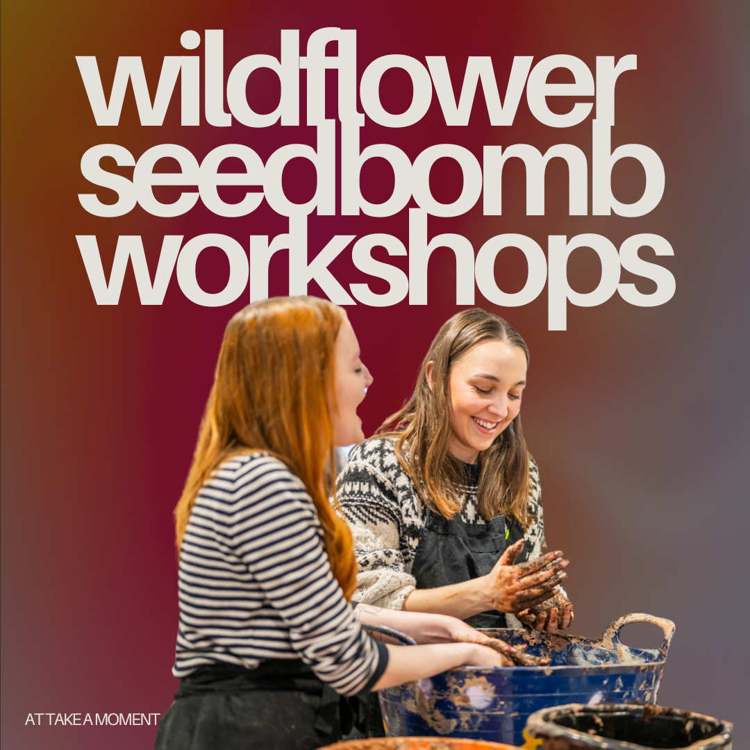 Two young women at a wildflower seed bomb workshop, smiling and hands covered in mud. They are engaged in a creative outdoor activity.