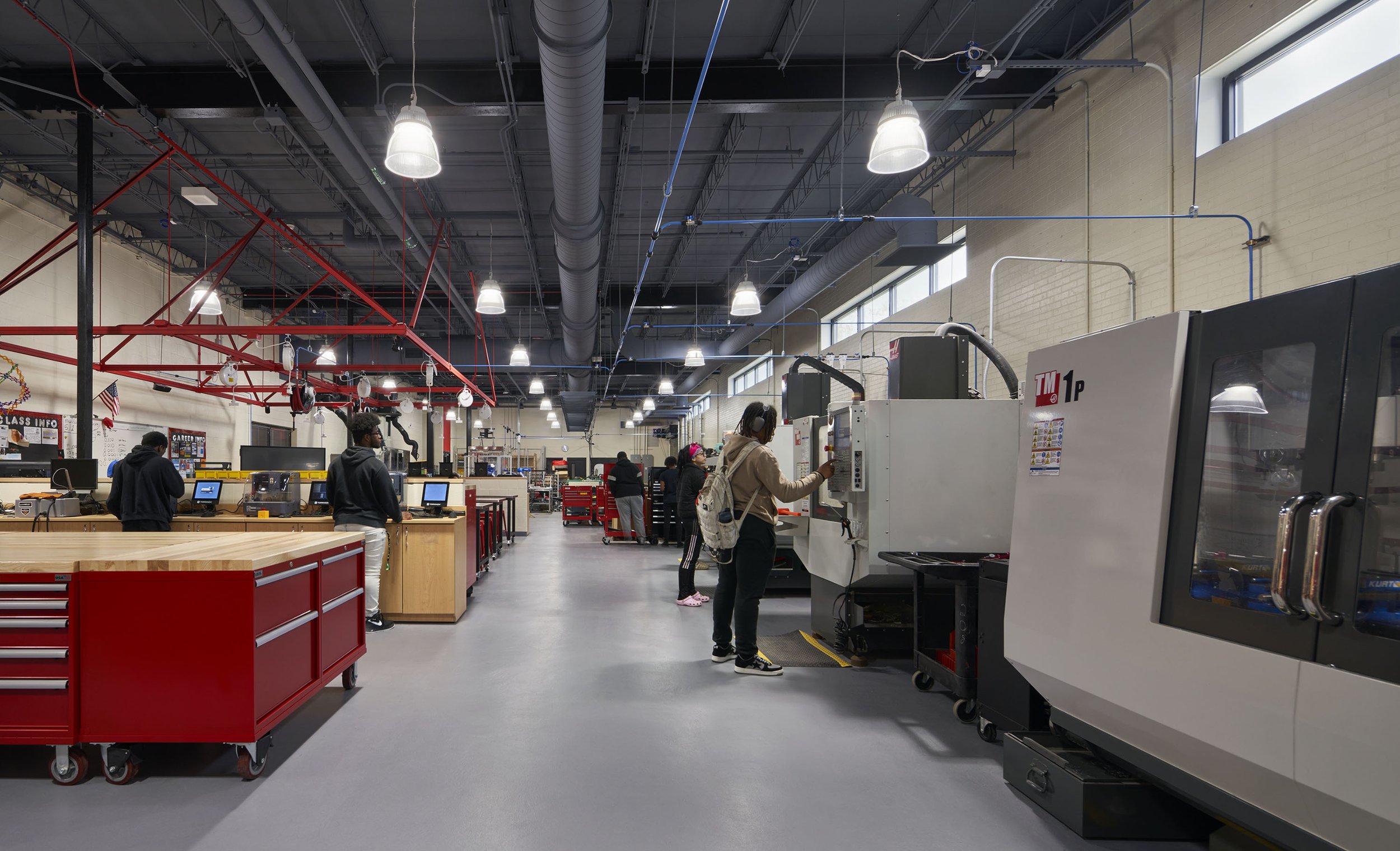The engineering classroom includes a robotics cage in the center of the room for hands-on experimentation, while the manufacturing lab is significantly larger than the previous space being used for the program. "The STEM and science rooms really got
