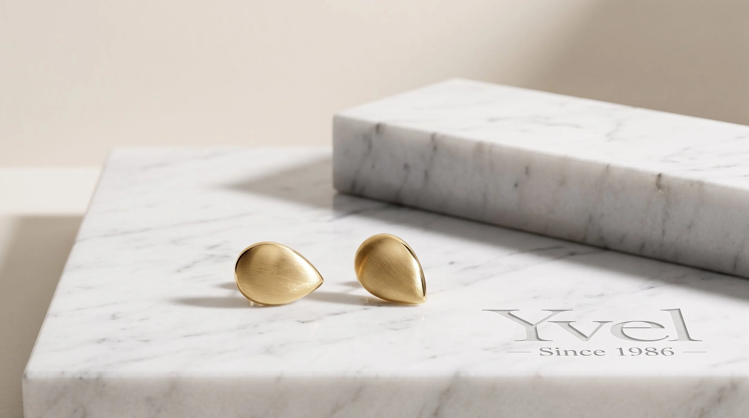 Two_earrings_on_marble_slab_202608201303.jpeg
