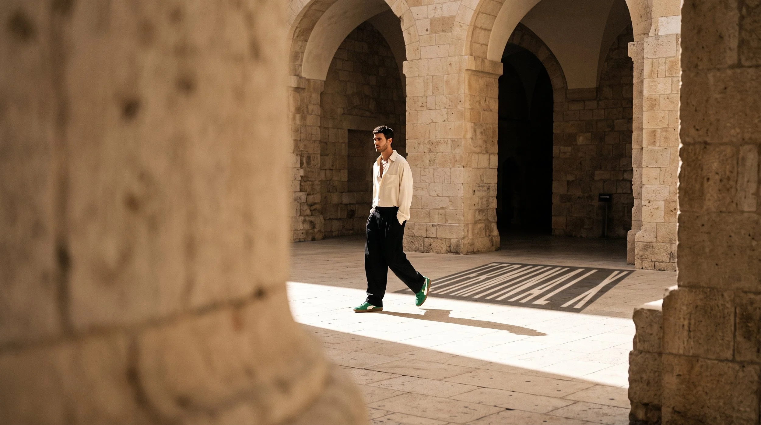 Man_walking_through_stone_corridor_202608181117 (1).jpeg