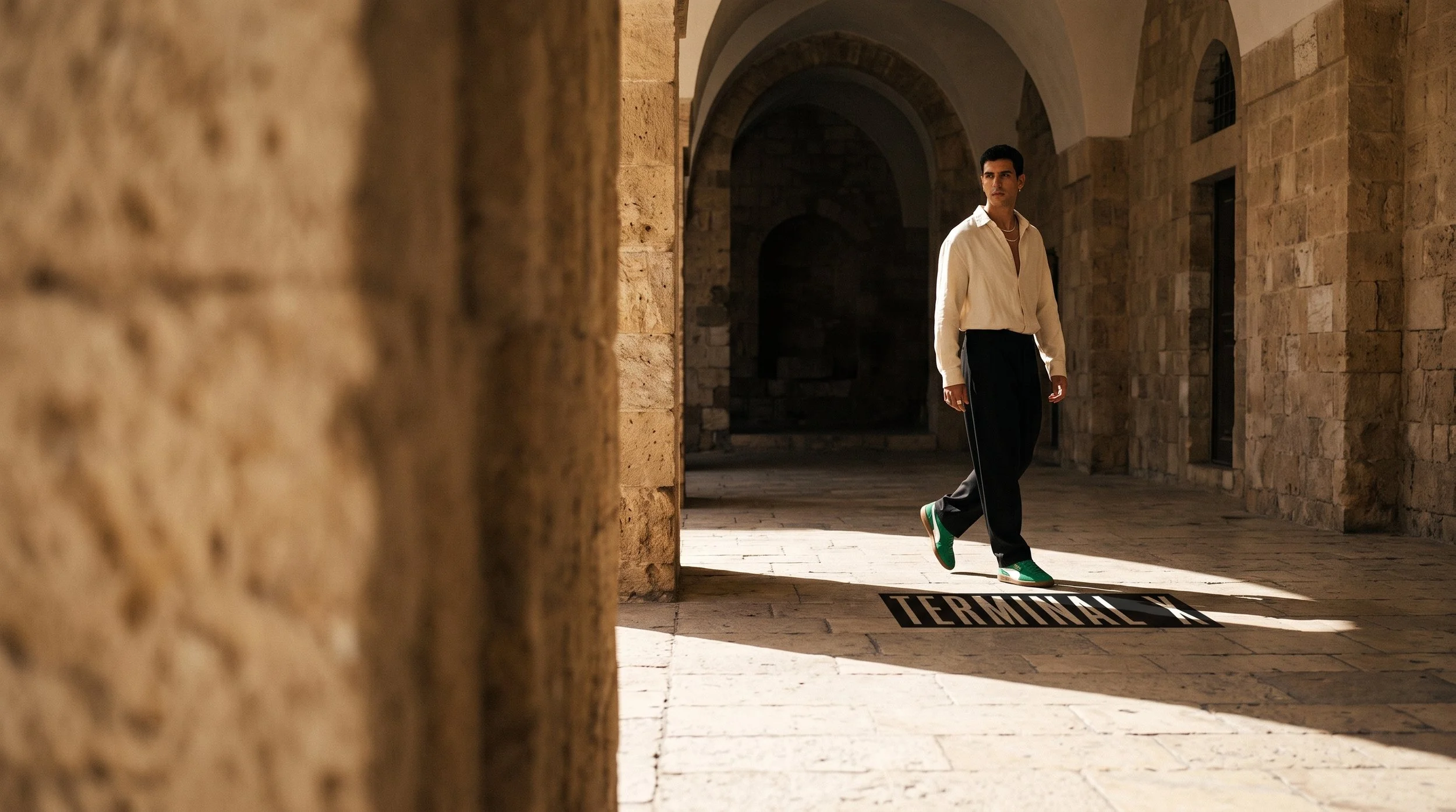 Man_walking_through_stone_corridor_202608181117.jpeg
