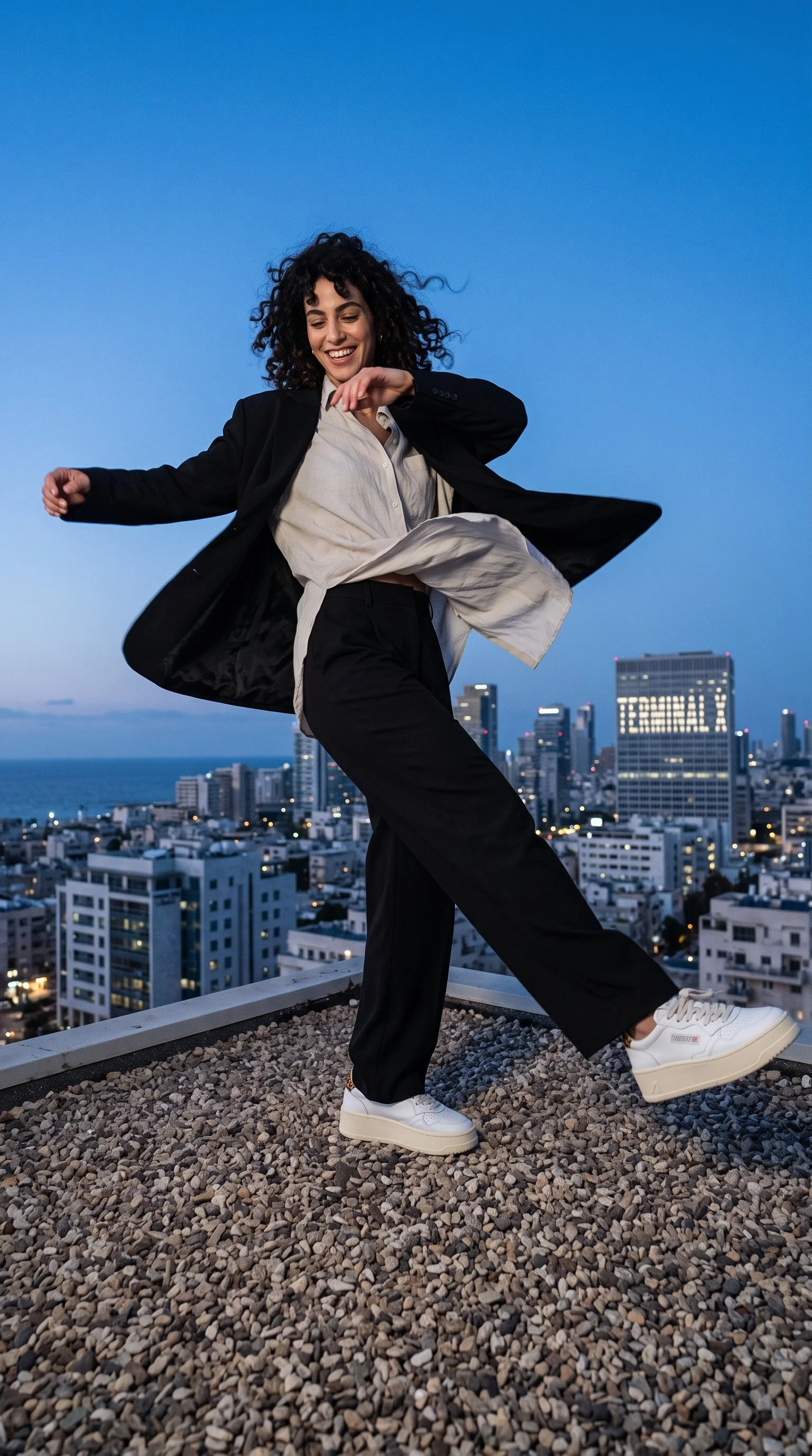 Woman_dancing_on_rooftop_2K_202608181428 (1).jpeg