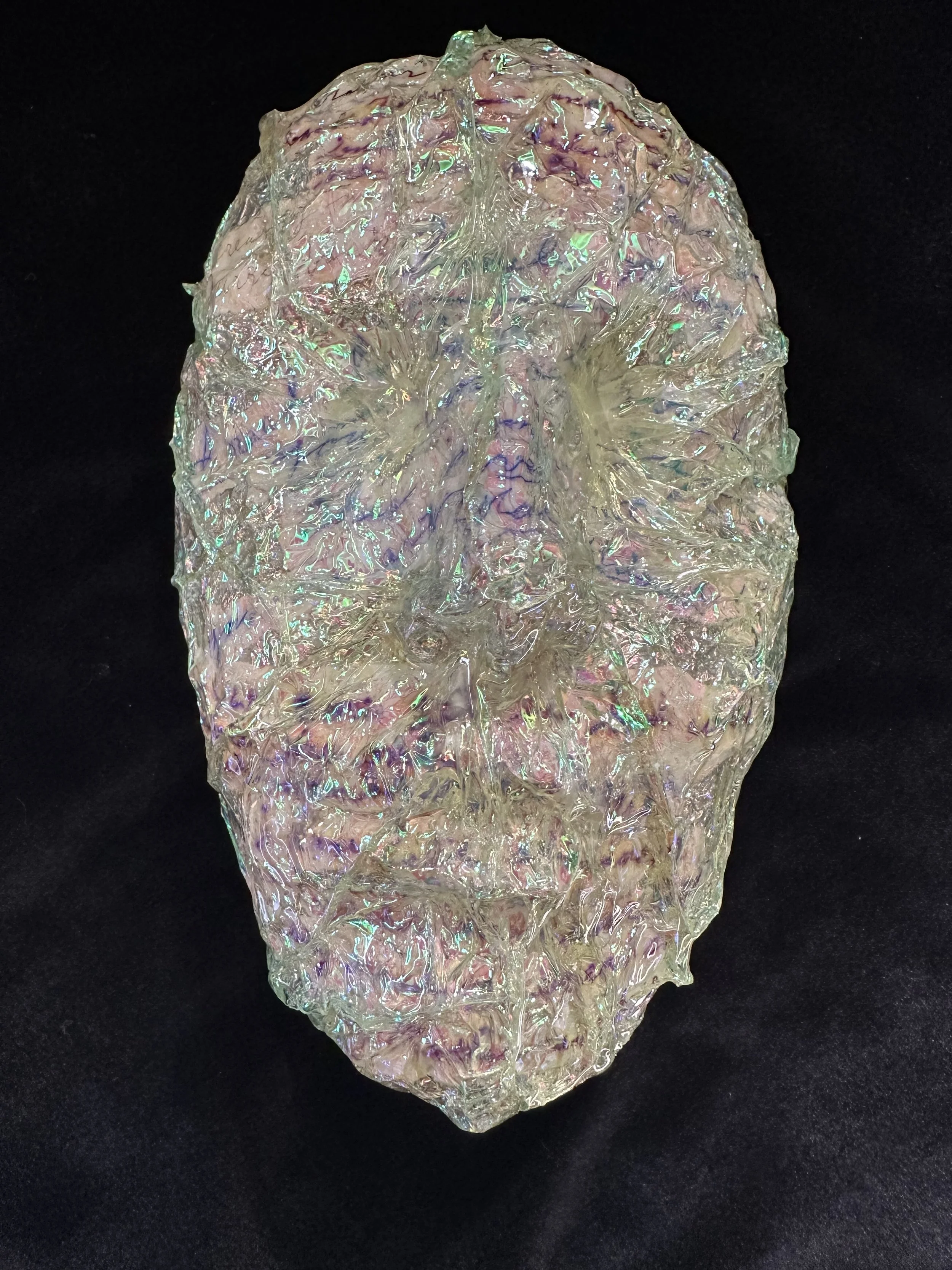 "Notes Through the Veil", Laura Nelen, papier-mâché clay, iridescent shrink film, Granny's notes, acrylic paint and resin, 8"x5"x3", 2024.