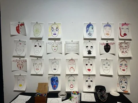 The community was invited to decorate their own death mask. The completed coloring pages will be bound into a book.