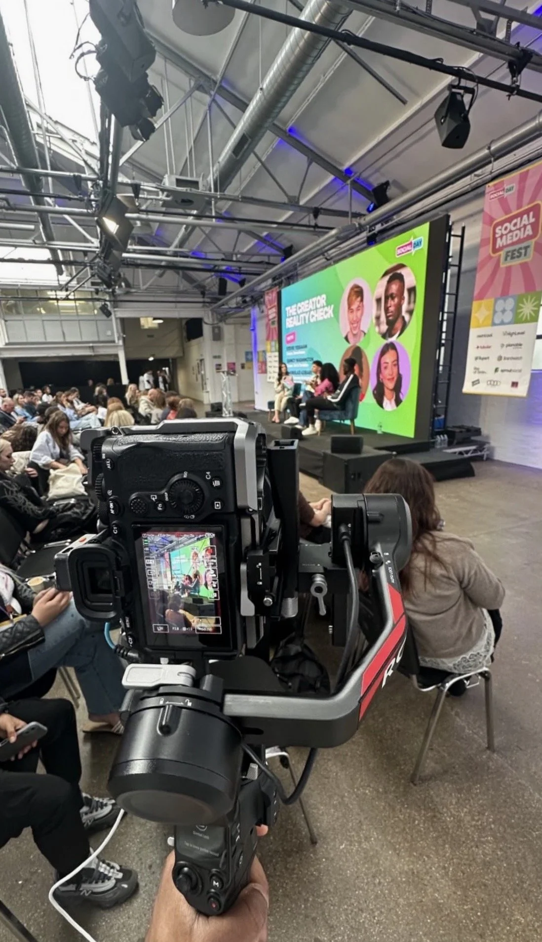 camera Panel discussion at SocialDay Fest featuring creators and social media professional influencers speaking on stage.