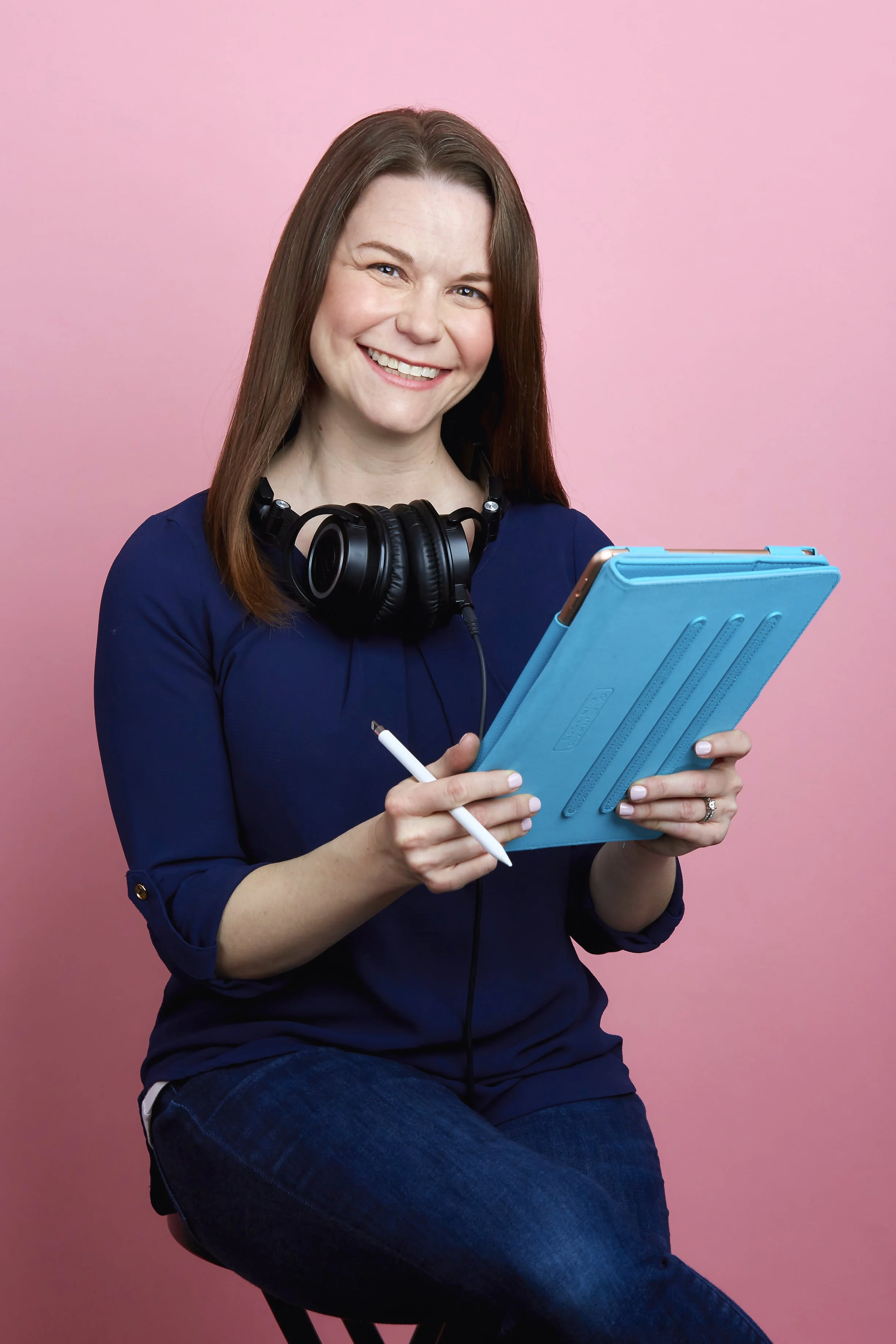 Professional female voice over actor for medical narration looks at her iPad with headphones on