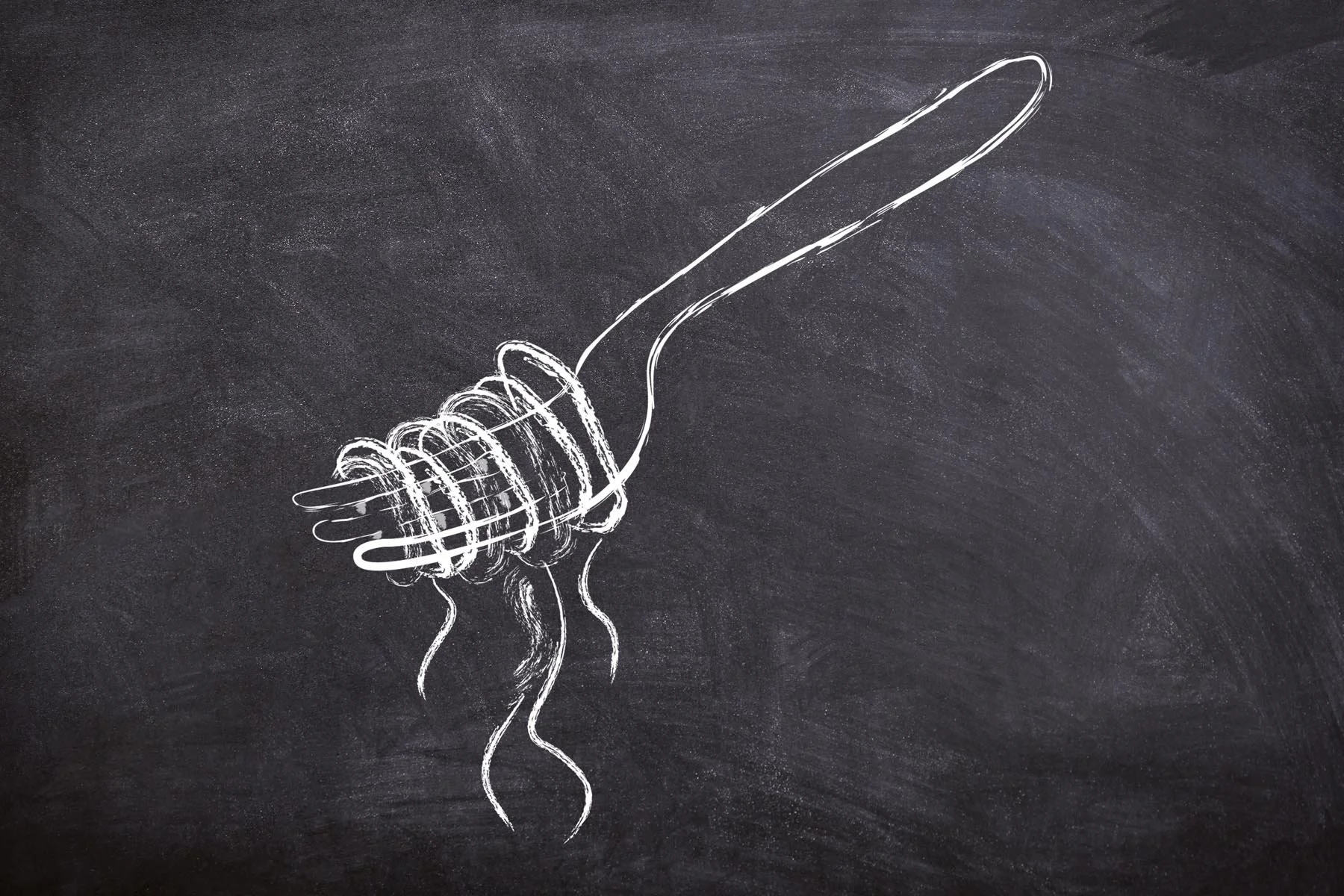 Chalk drawing of a fork twirling spaghetti on a blackboard.