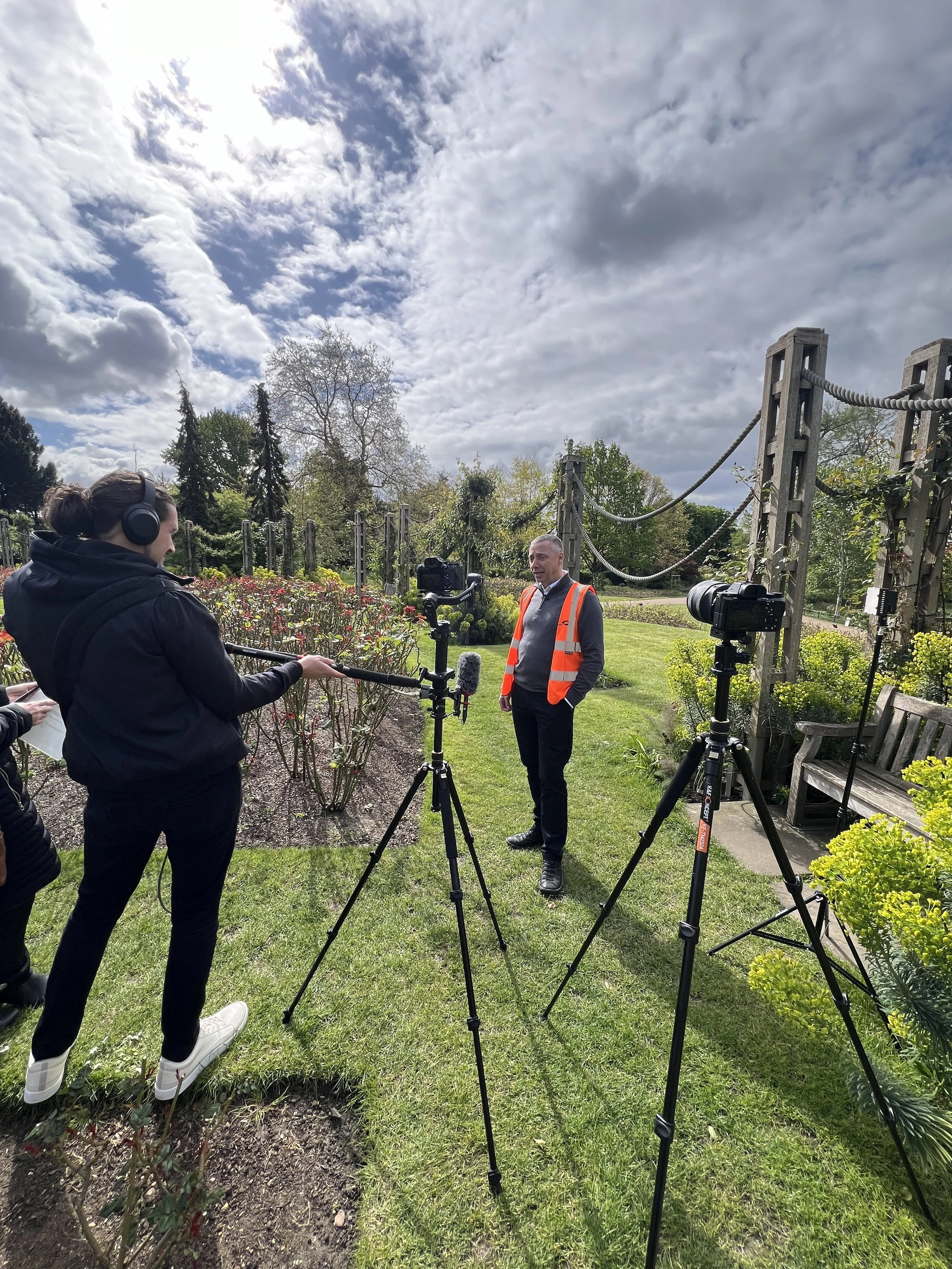 man video and audio recording another man dressed in high vis jacket