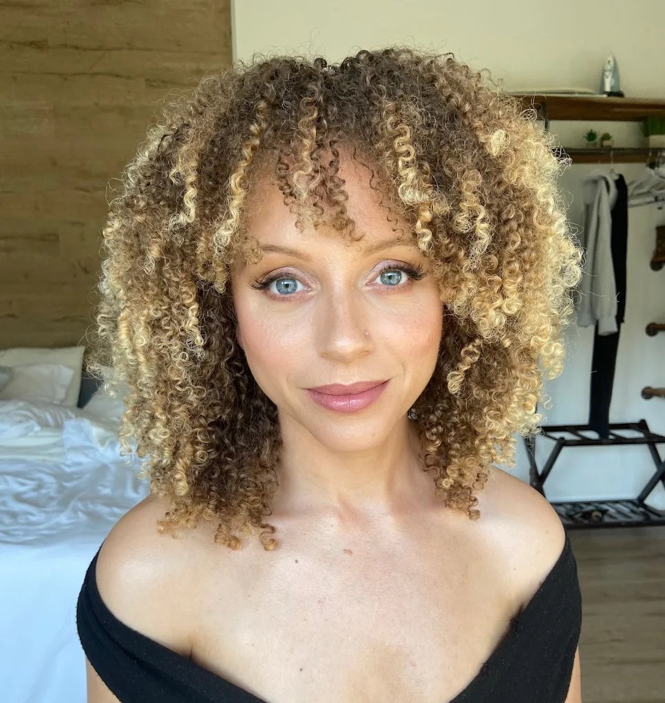 Smiling bride with medium brown hair and bronzy, radiant skin tone, glowing with fresh, natural bridal makeup designed for a timeless wedding day in Los Angeles.
