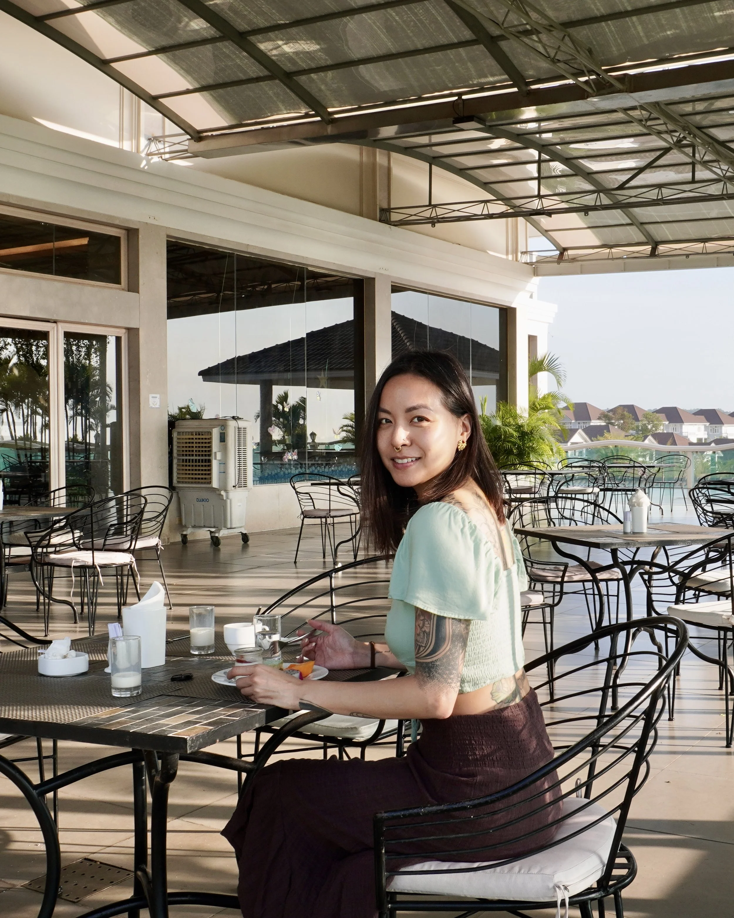 Gina Dang looking over shoulder while dining