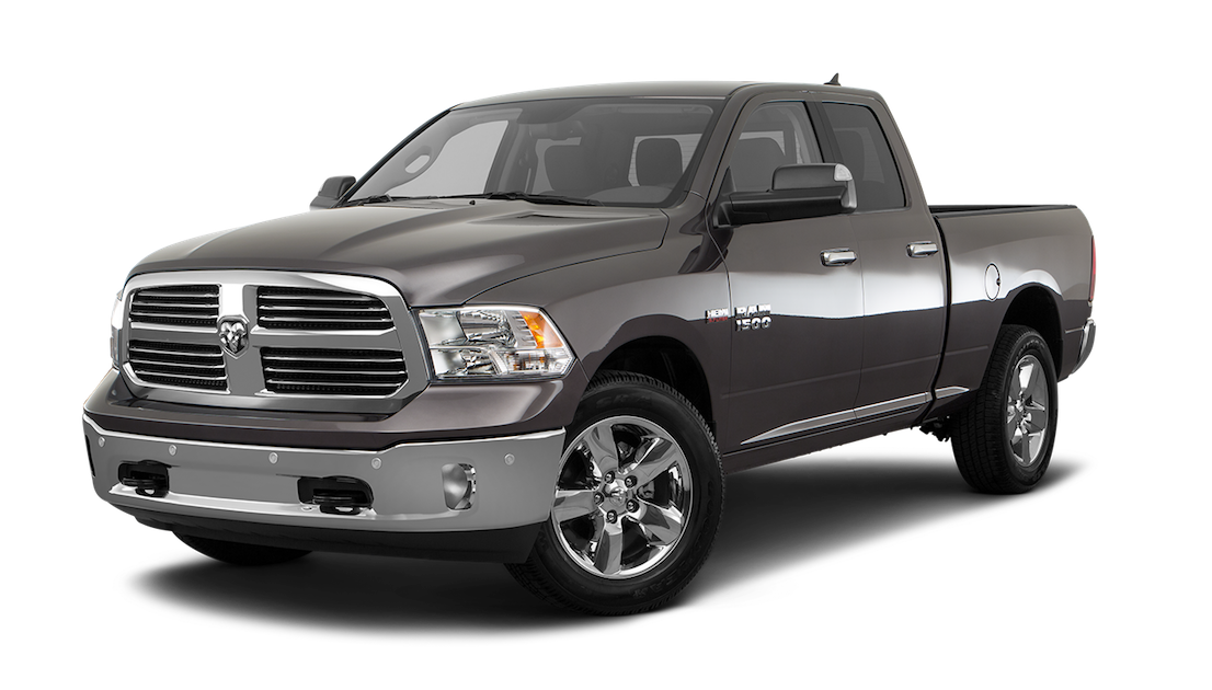 Black and gray Dodge Ram 1500 pickup truck with four doors, chrome grille, and alloy wheels.