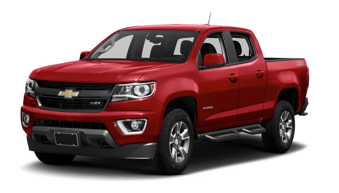 Red Chevrolet Colorado Z71 pickup truck with black grille, headlights, and silver wheels, parked against a white background.