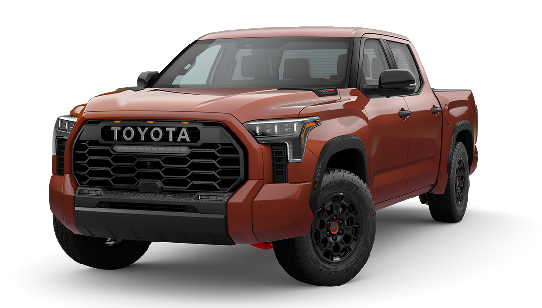 A red Toyota pickup truck with a large black front grille, black wheels, and four doors.