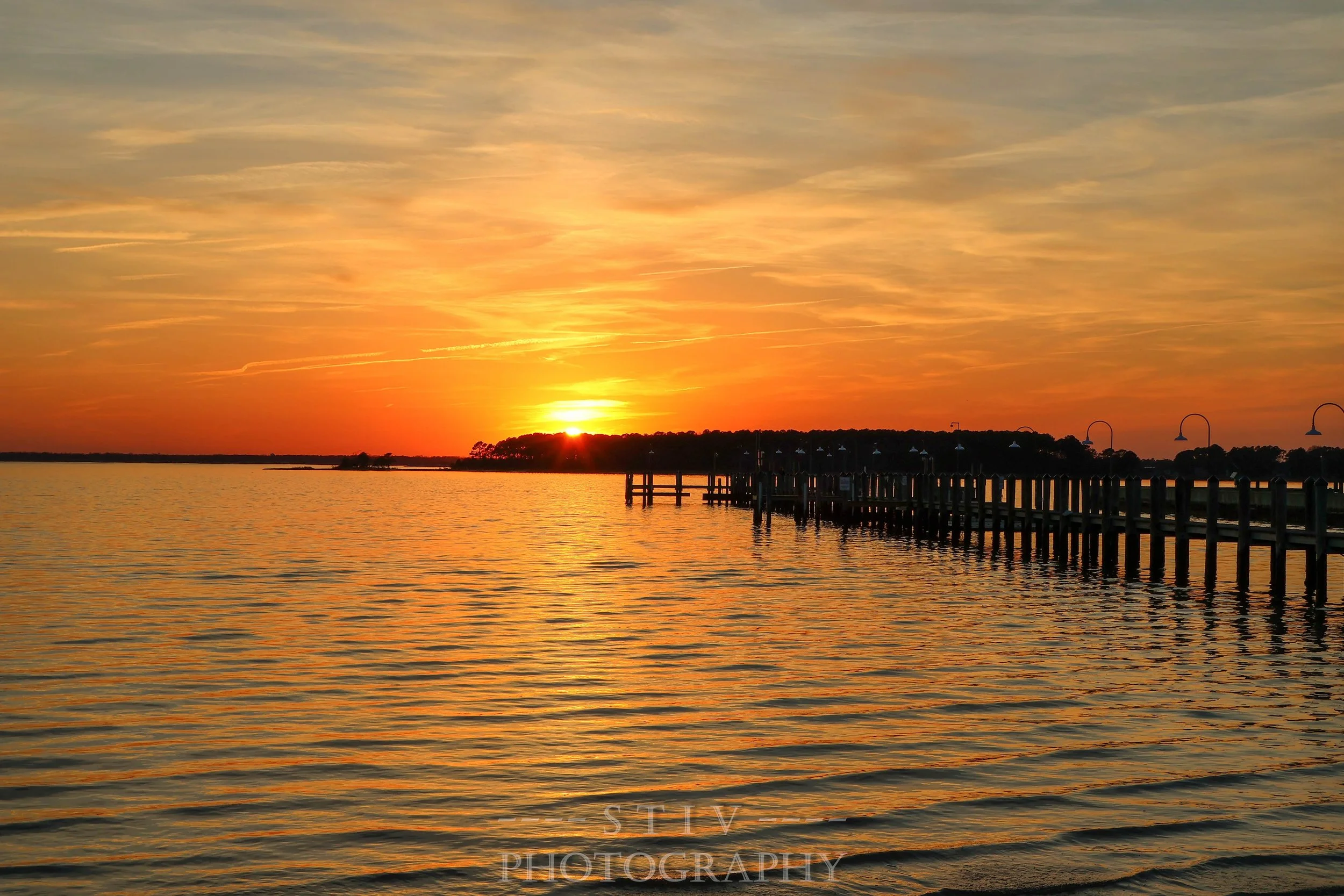 Sunset over the bay in Dewey Beach behind the Rusty Rudder.
