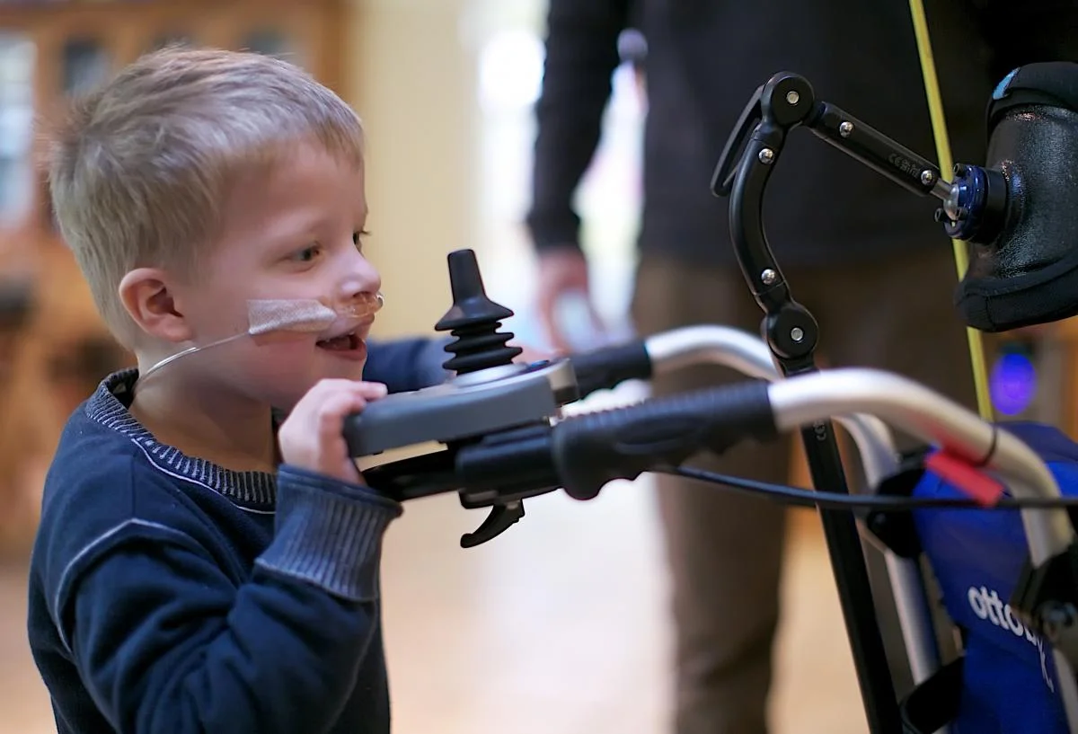 child looking at special wheelchair