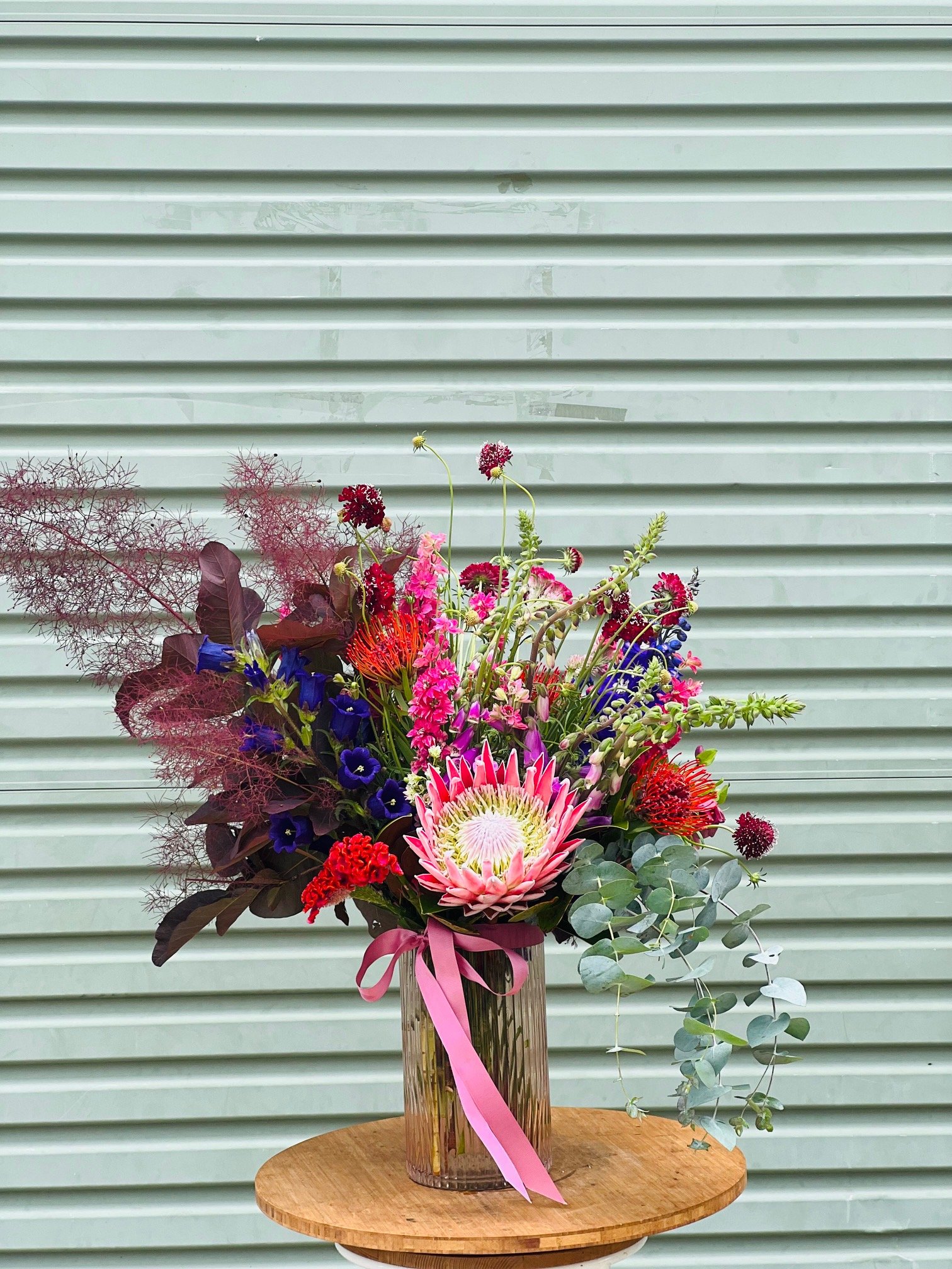 bouquet in glass vase, native and mixed flowers, florist choice, king protea, smoke bush, canterbury bells, bright flowers, flax flower, fresh flowers dleivery daily, sunshine coast florist, mount coolum florist.jpg