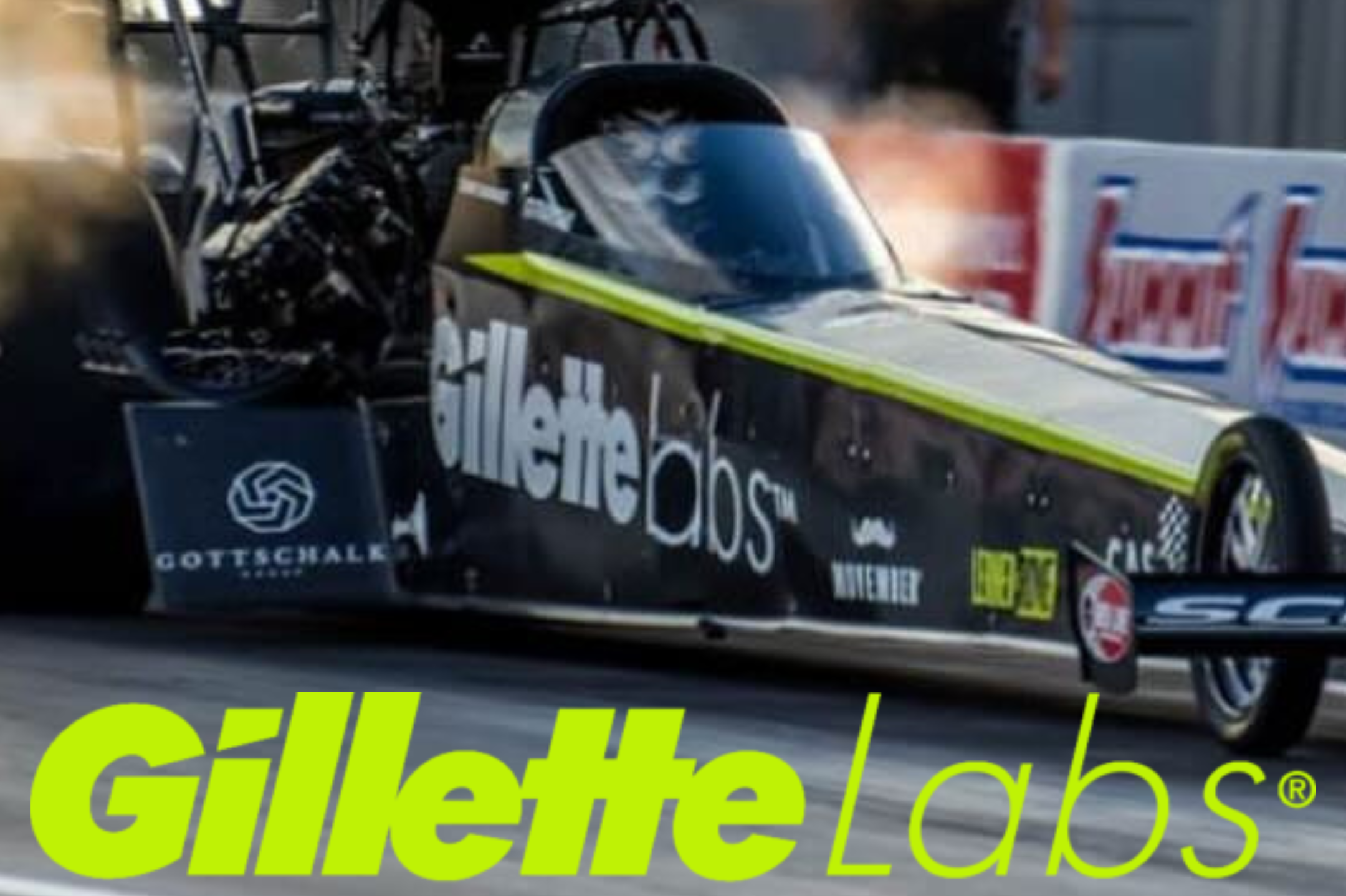Travis Shumake's Dragster with Gillette Labs branding, emitting smoke during a race.