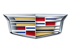Close-up of a Cadillac emblem with a shield design and red, blue, and silver accents.