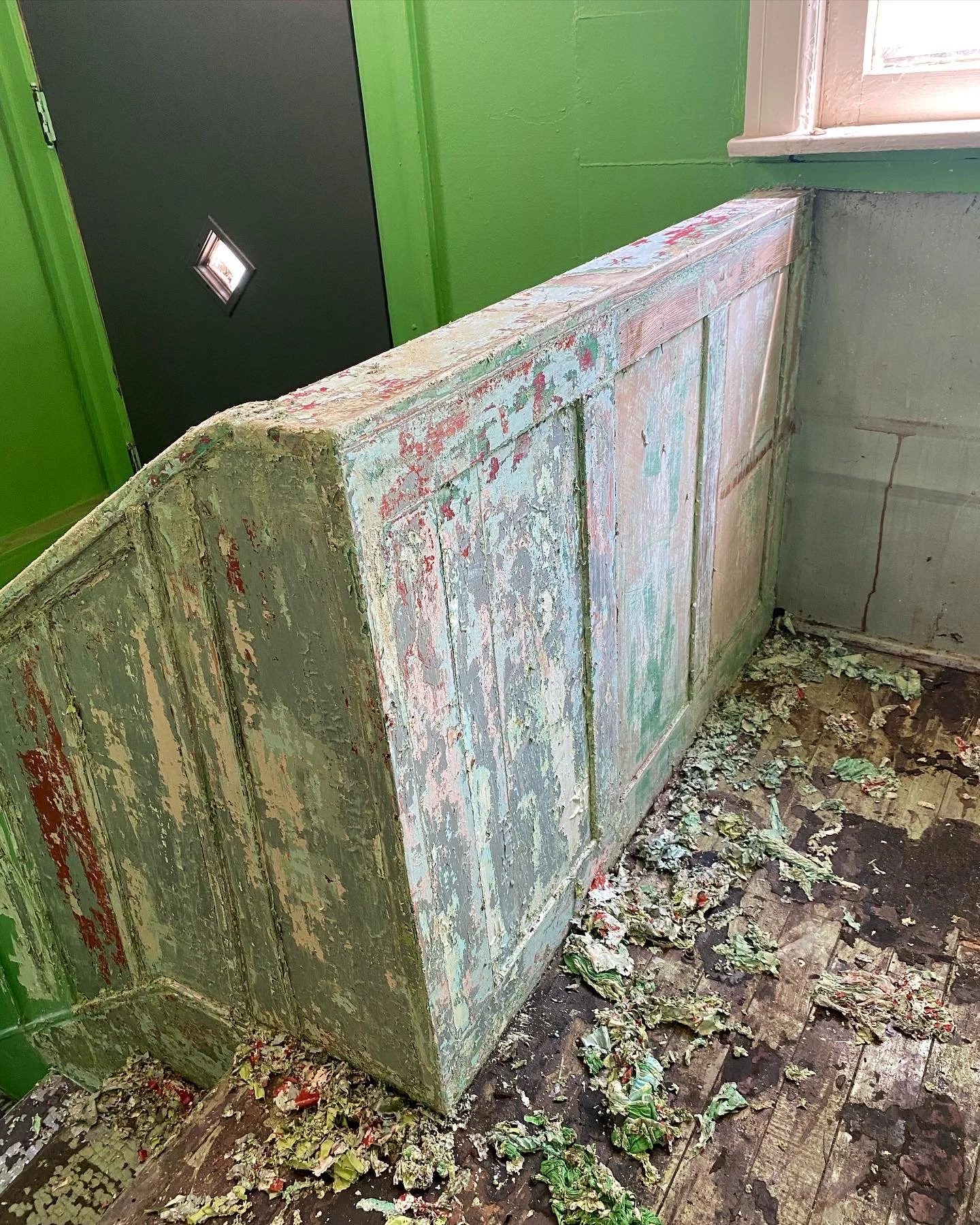 Banister that has been painted and damaged. 