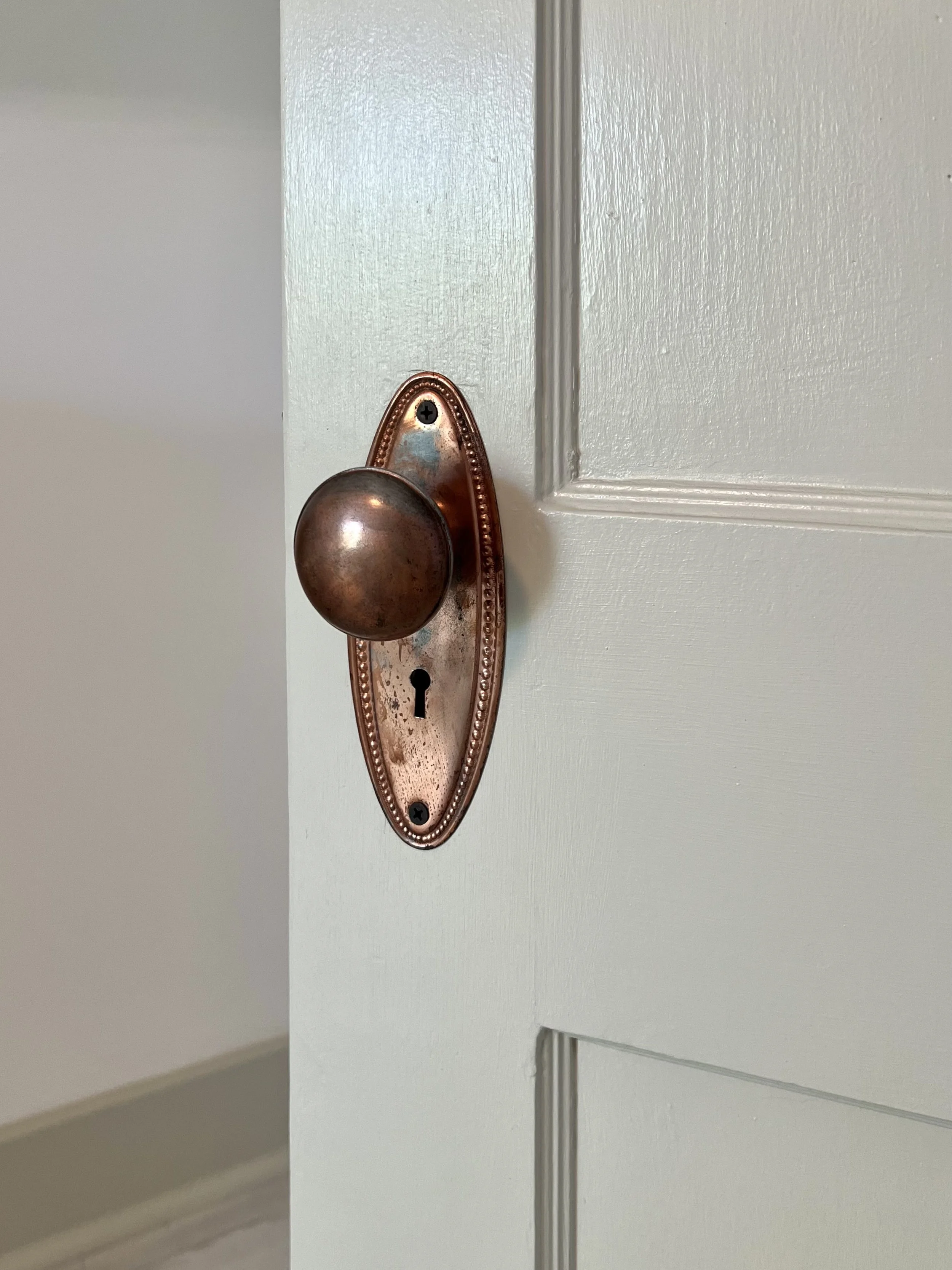 Restored door with brass plated door knob and plate.