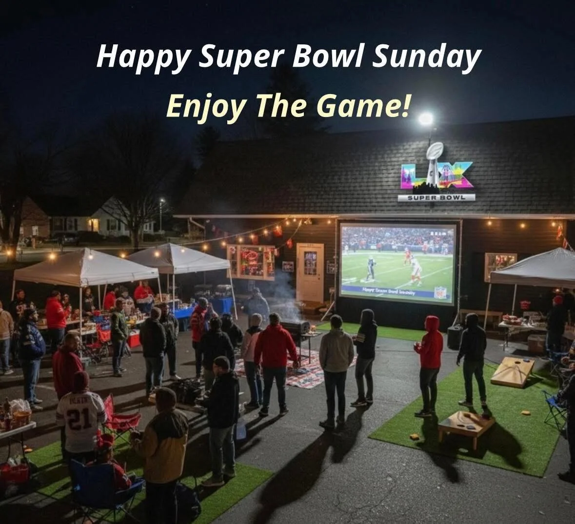 Outdoor Super Bowl viewing party at night with people, tents, and a large screen showing a football game, decorations, and text saying "Happy Super Bowl Sunday, Enjoy The Game!"