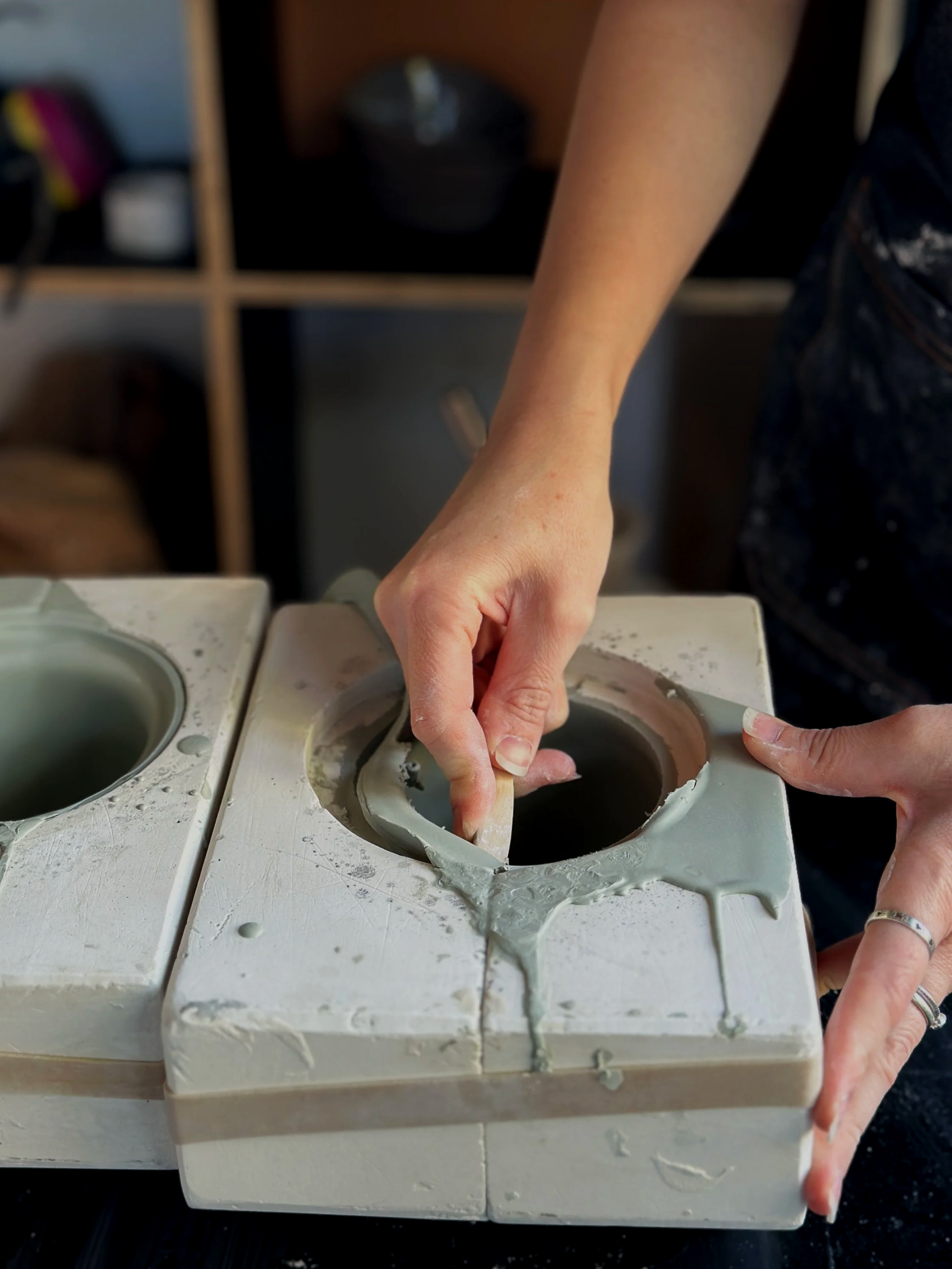 Deanna trimming a porcelain ceramic cup rim