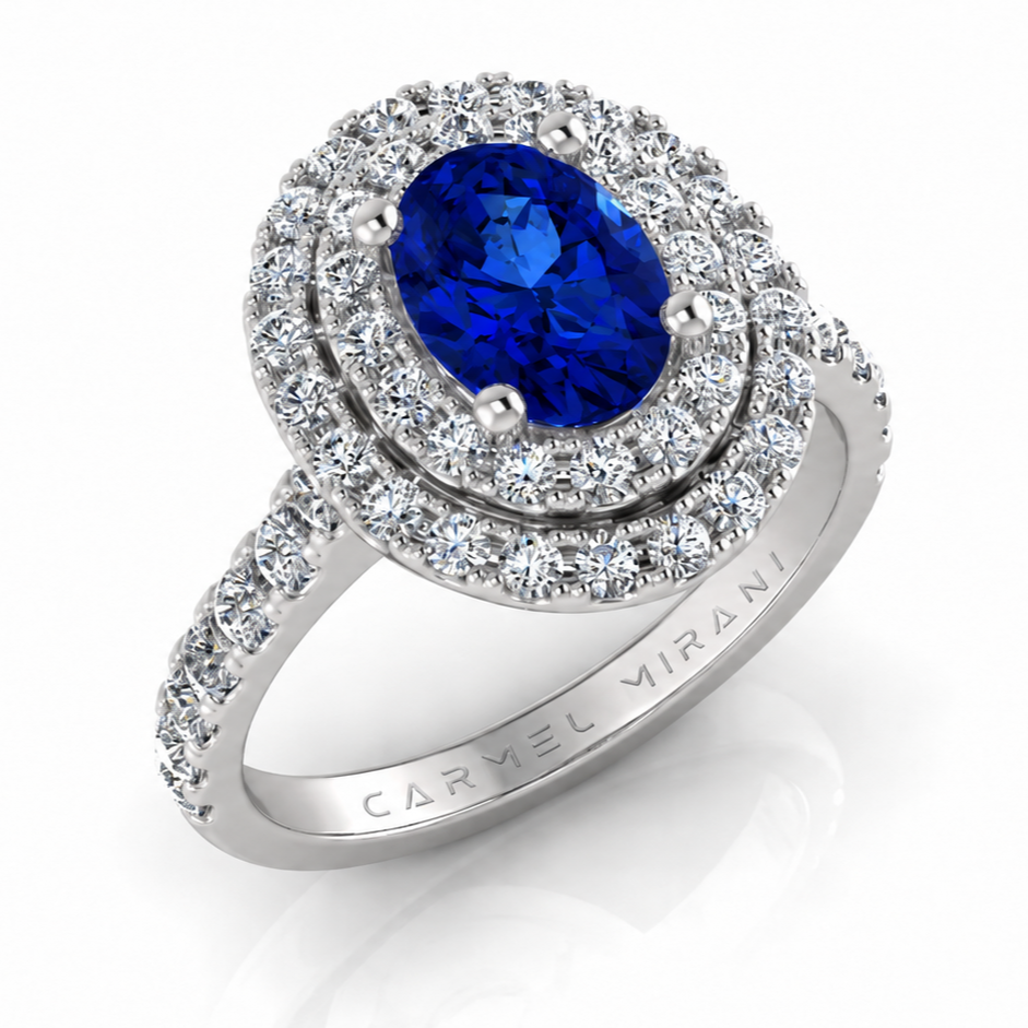 Silver ring with a large oval blue gemstone surrounded by diamonds, inscribed with 'CARMEL MIRANI' on the inner band.