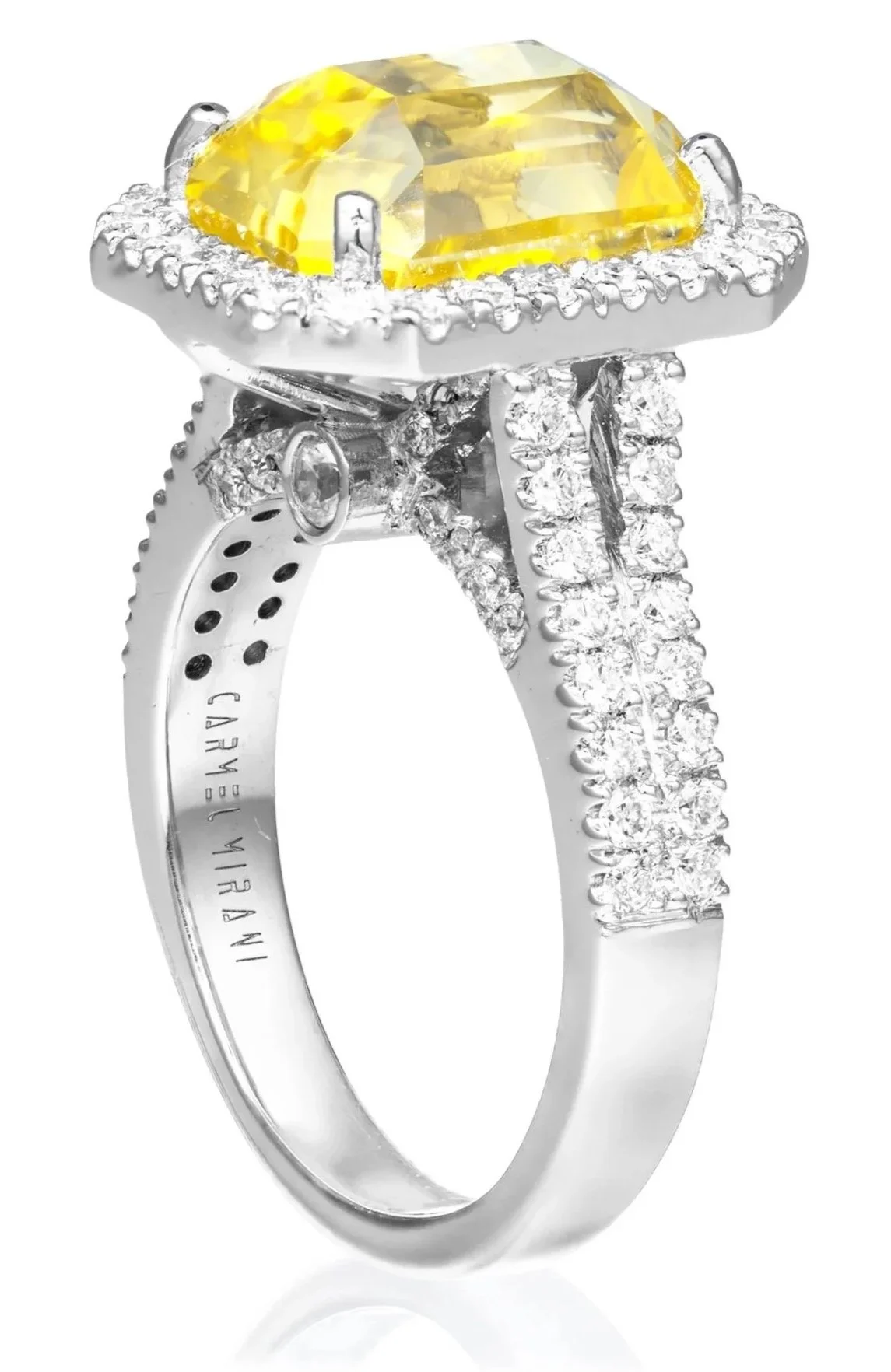 A silver ring featuring a large yellow gemstone in the center, surrounded by a halo of small diamonds, with additional diamonds on the band.