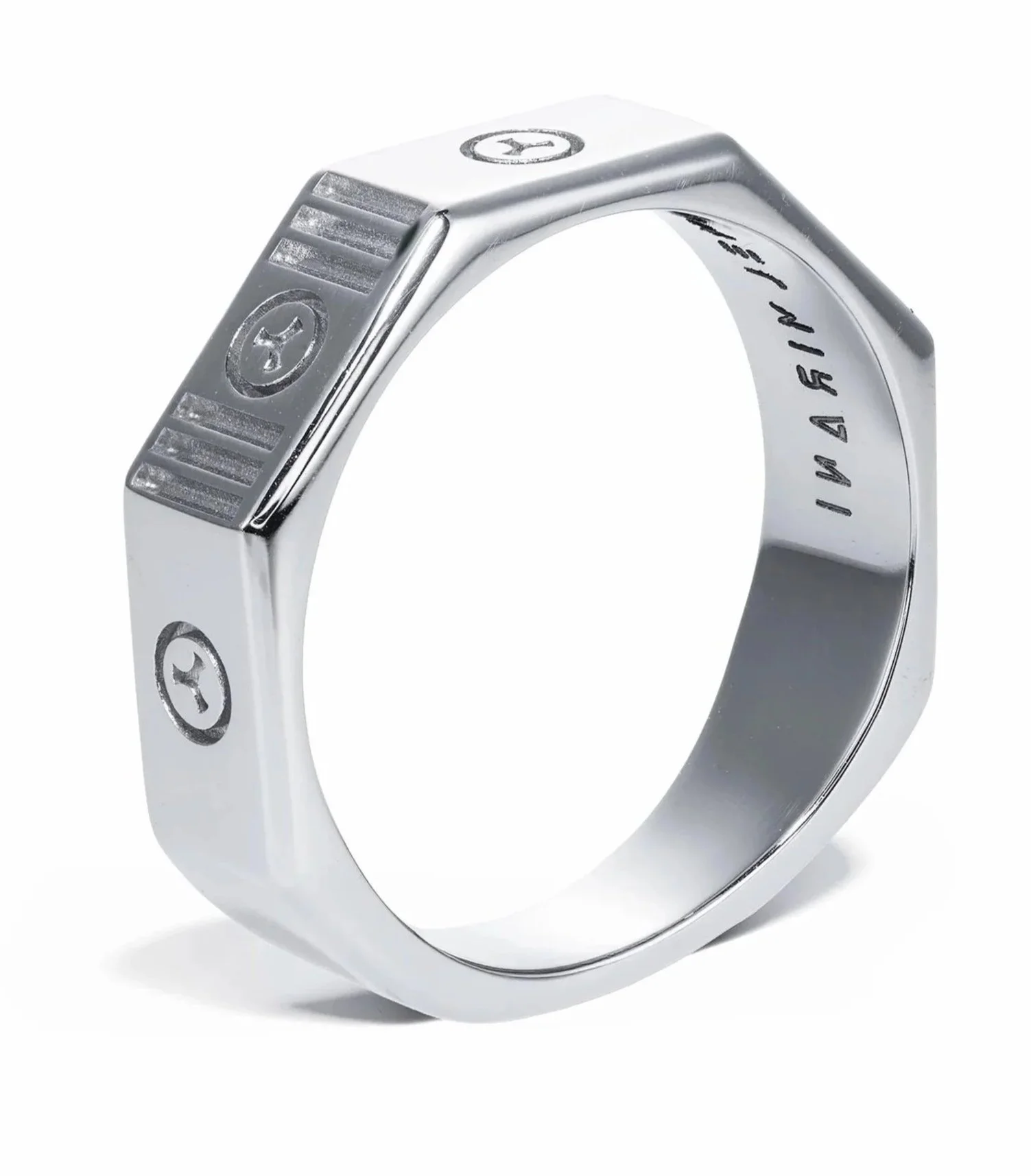 Close-up of a silver ring with engraved screws and a circular pattern with a star in the center.
