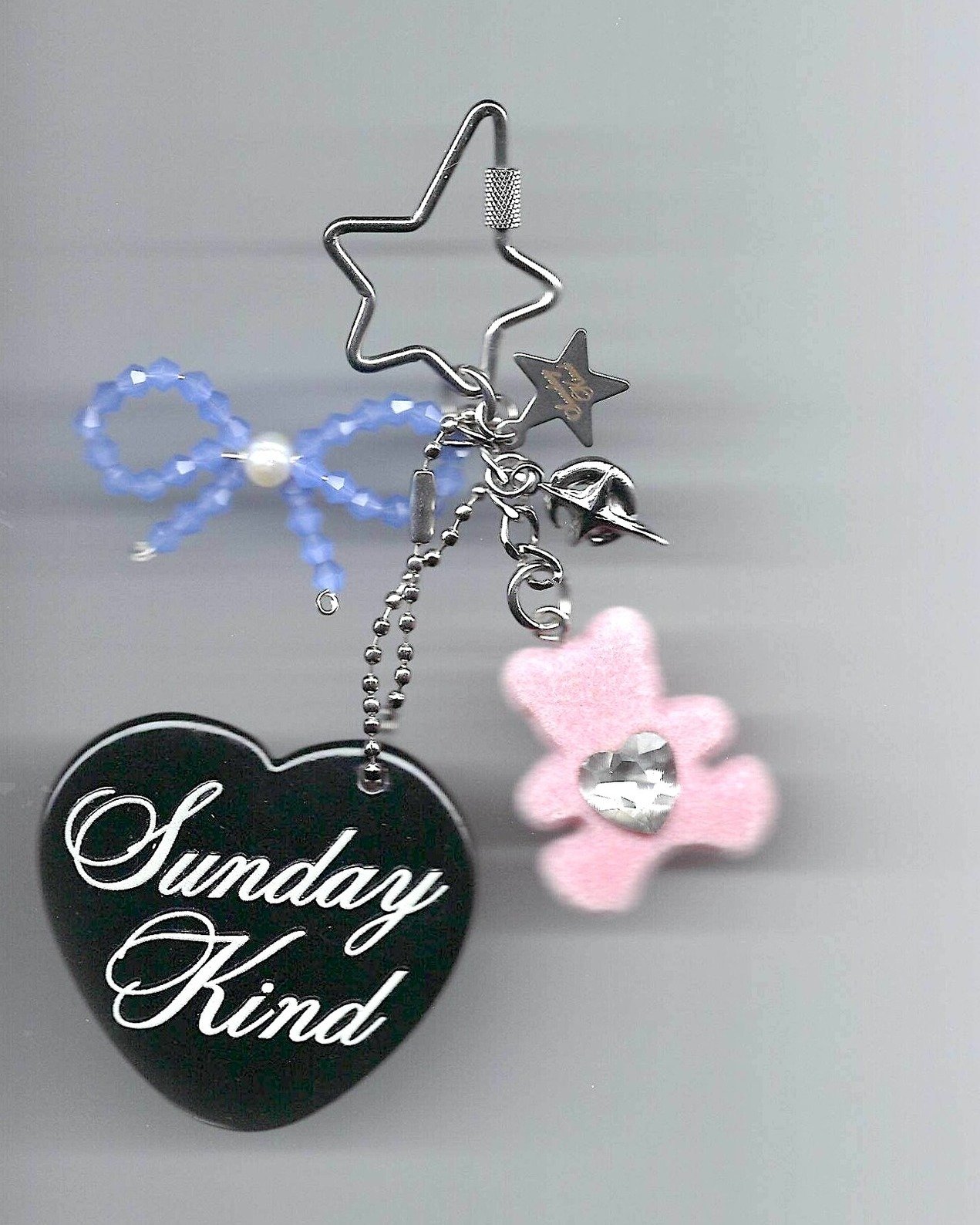 the mimi charm - a blue beaded bow, pink bear, and tiny star and moon gathered around our heart mirror. Soft, sweet, and full of small wishes. ✨🧸🎀🌠