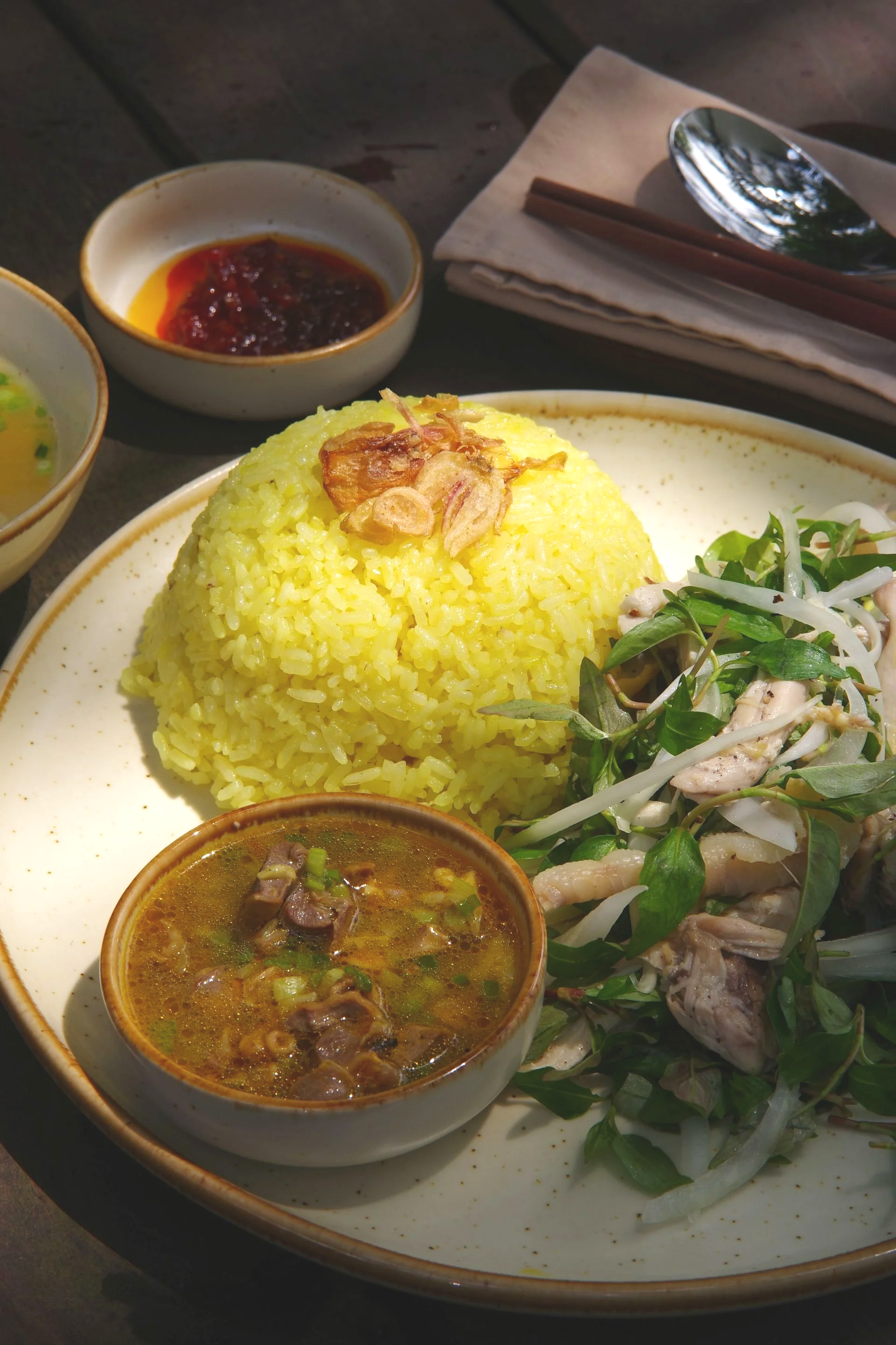 Chicken rice with shredded chicken fresh herbs and chilli