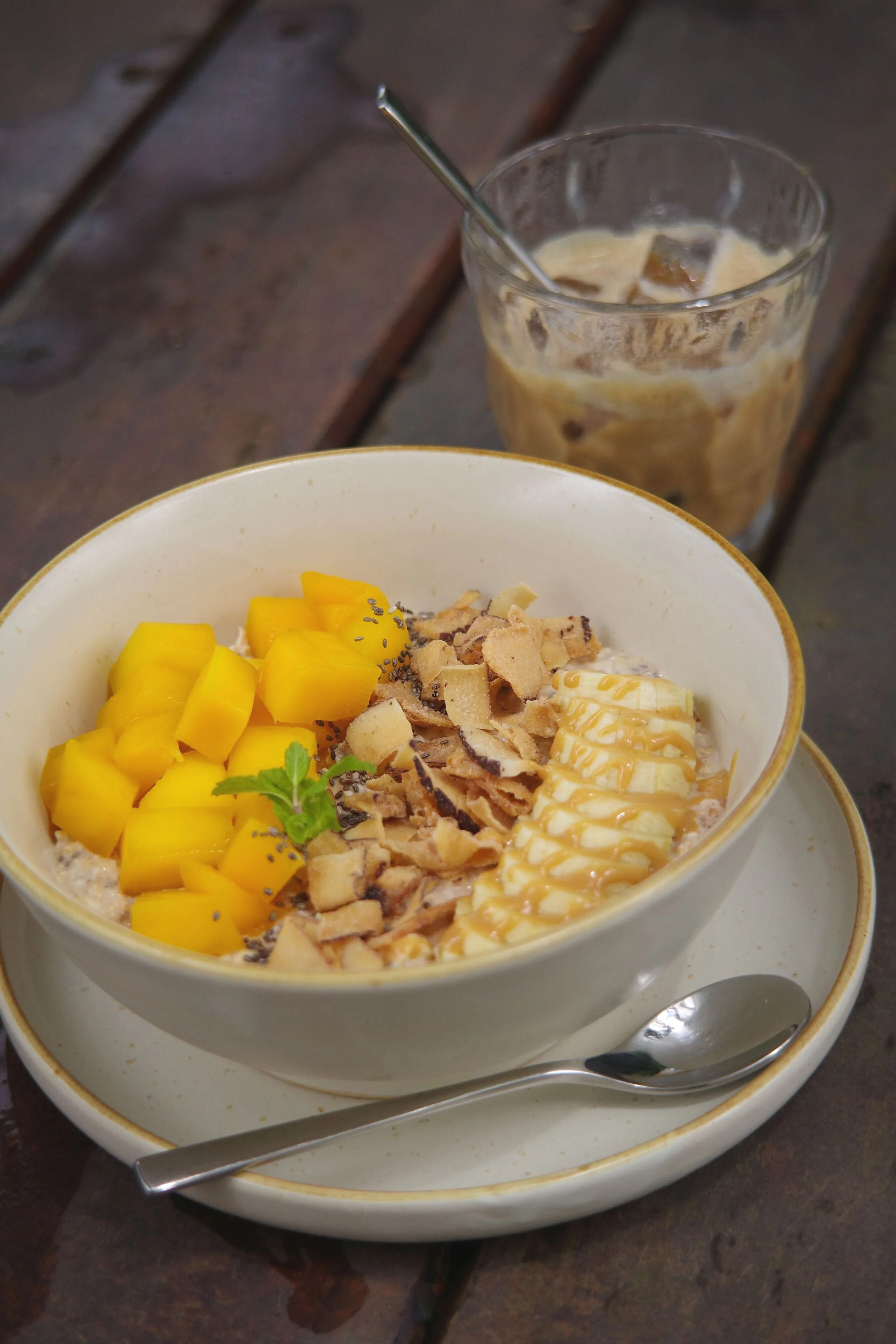 Overnight oats with fresh mango, banana, toasted coconut flakes and peanut butter