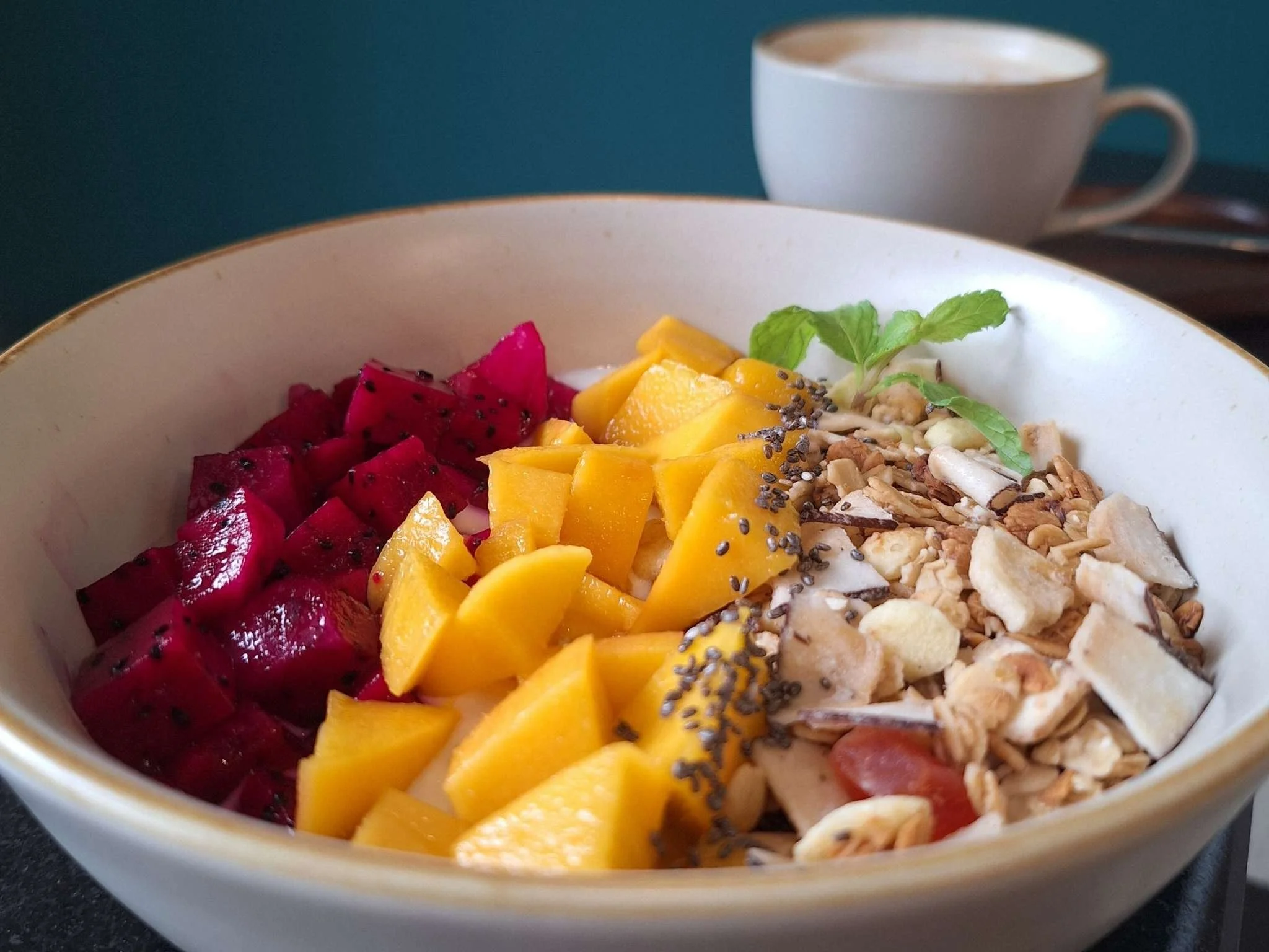 breakfast garden bowl with yoghurt mango, red dragon fruit and granola