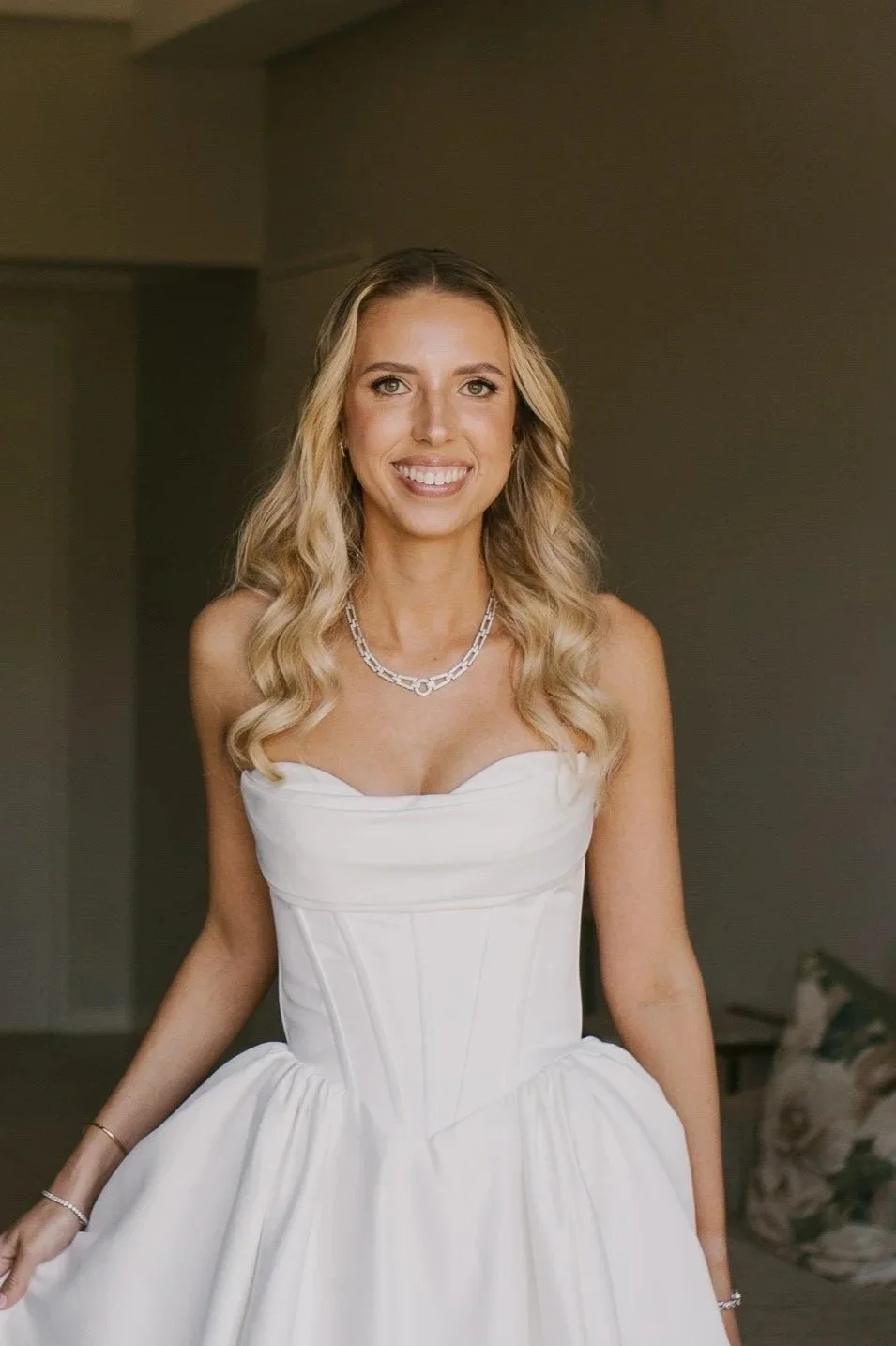 Bride with a fresh, natural bridal makeup look and softly styled hair.