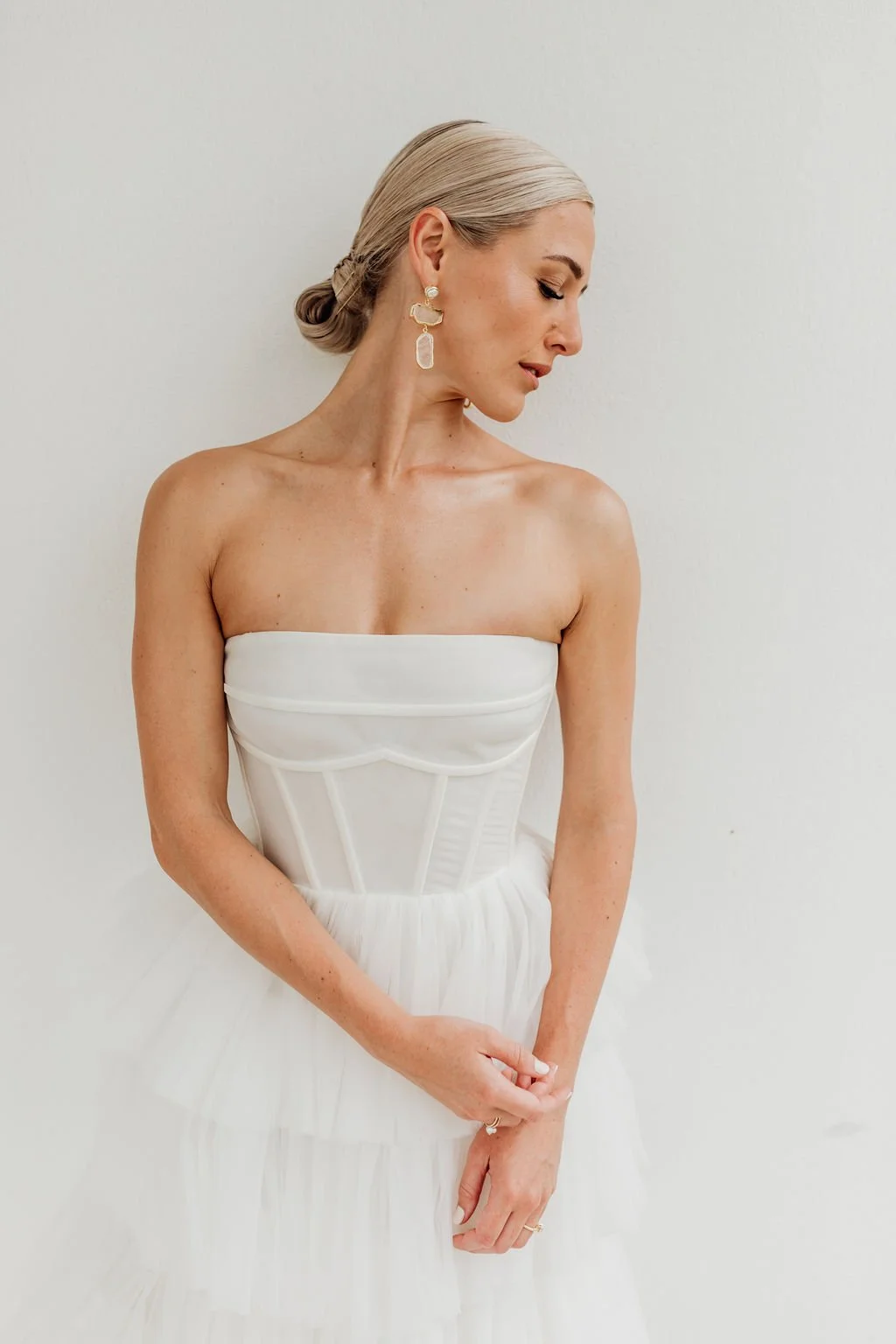Bride with a fresh, natural bridal makeup look and sleek low bun