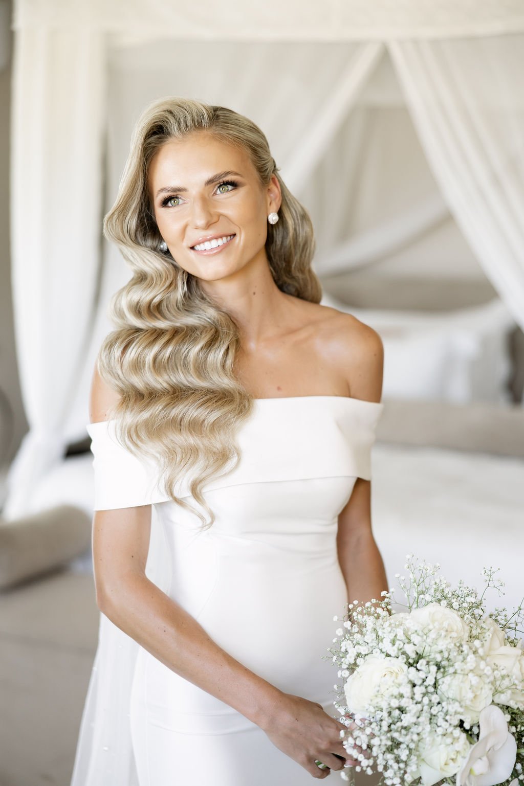 Bridal makeup artist applying airbrush makeup for a lightweight, natural-looking finish.