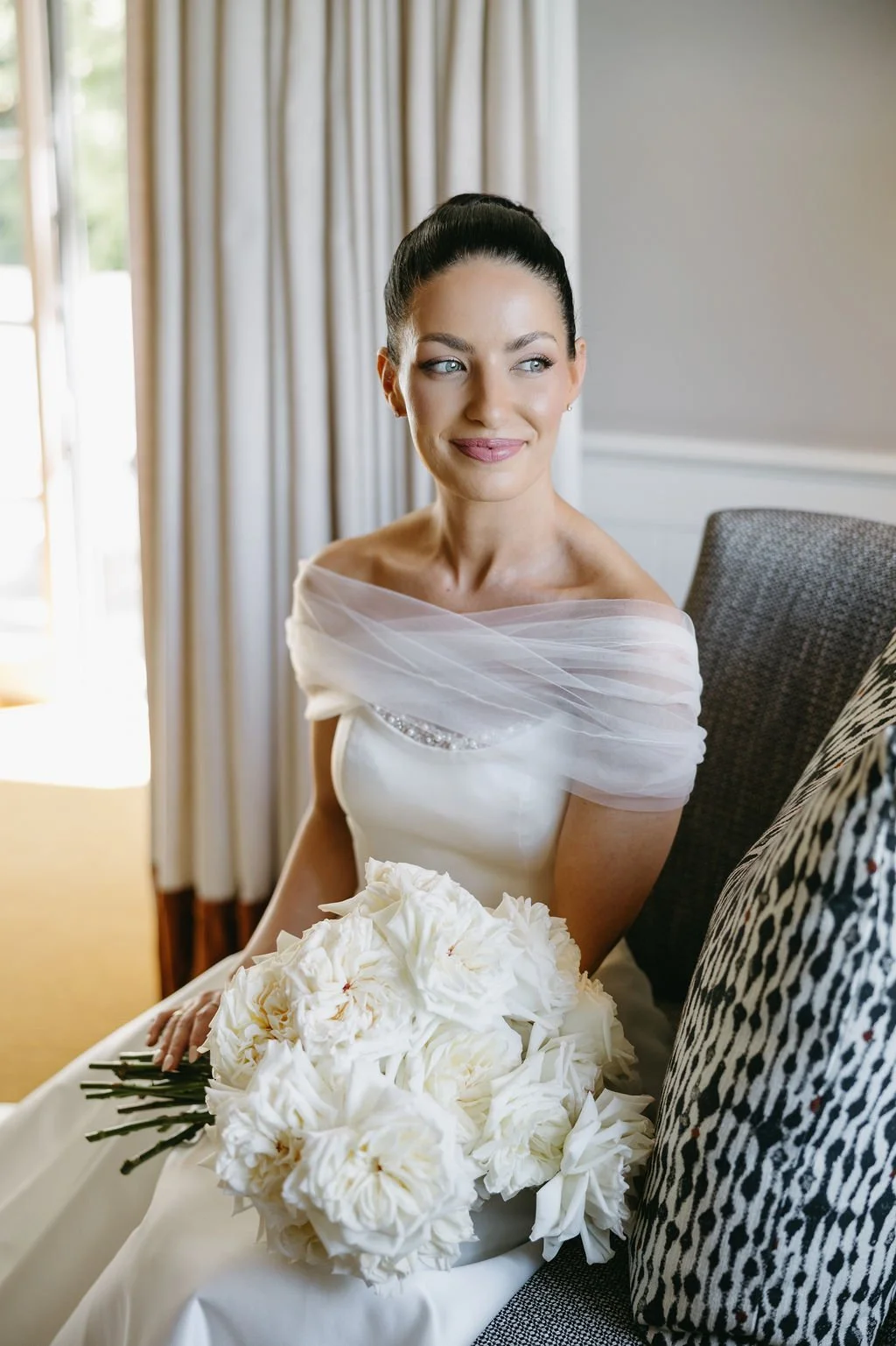 Bride with polished bridal makeup and softly styled hair on her wedding day.